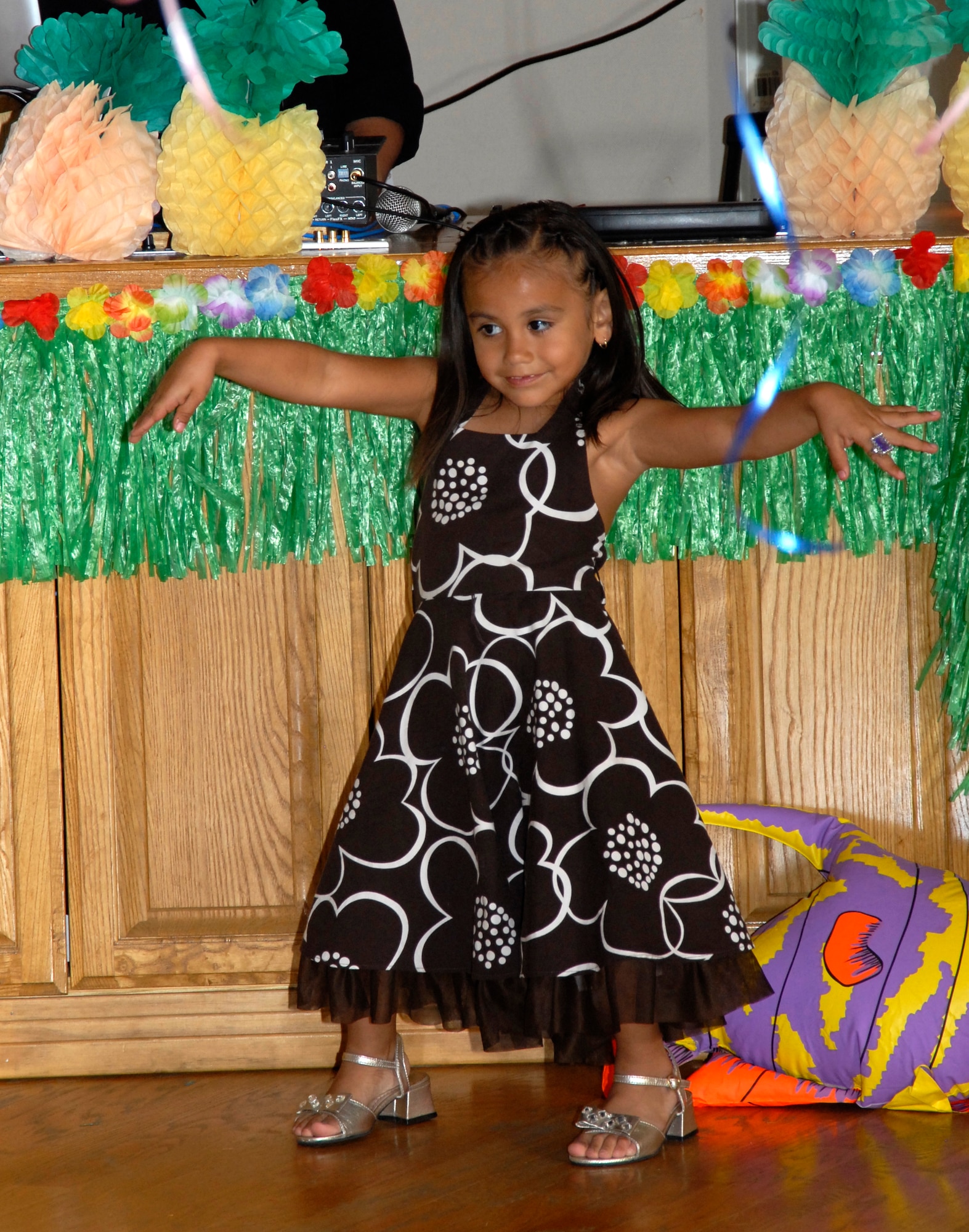 GOODFELLOW AIR FORCE BASE, Texas -- Six-year-old Gabriela Pena enjoys the spotlight during the Annual Daddy-Daughter Dinner and Dance at the Event Center June 16.  This year's theme was a Hawaiian Luau with almost 20 dad and daughter couples attending.  (U.S. Air Force photo/Connie Hempel)