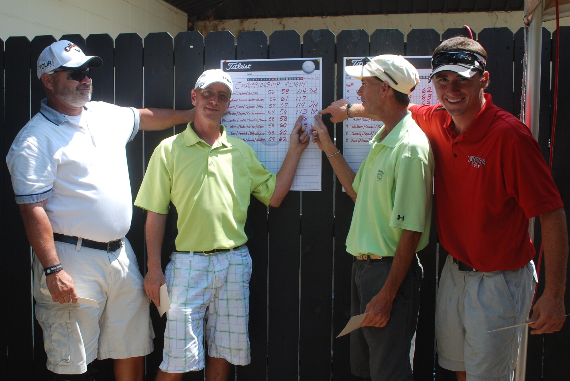 Arl Taylor, Zac Taylor, Dennis Cox and Joey Persechino point out their 1st place position on the 9th Annual Super Scramble score board at the Whispering Pines Golf Course on June 12. Sixteen teams played the two day tournament. (U.S. Air Force photo)