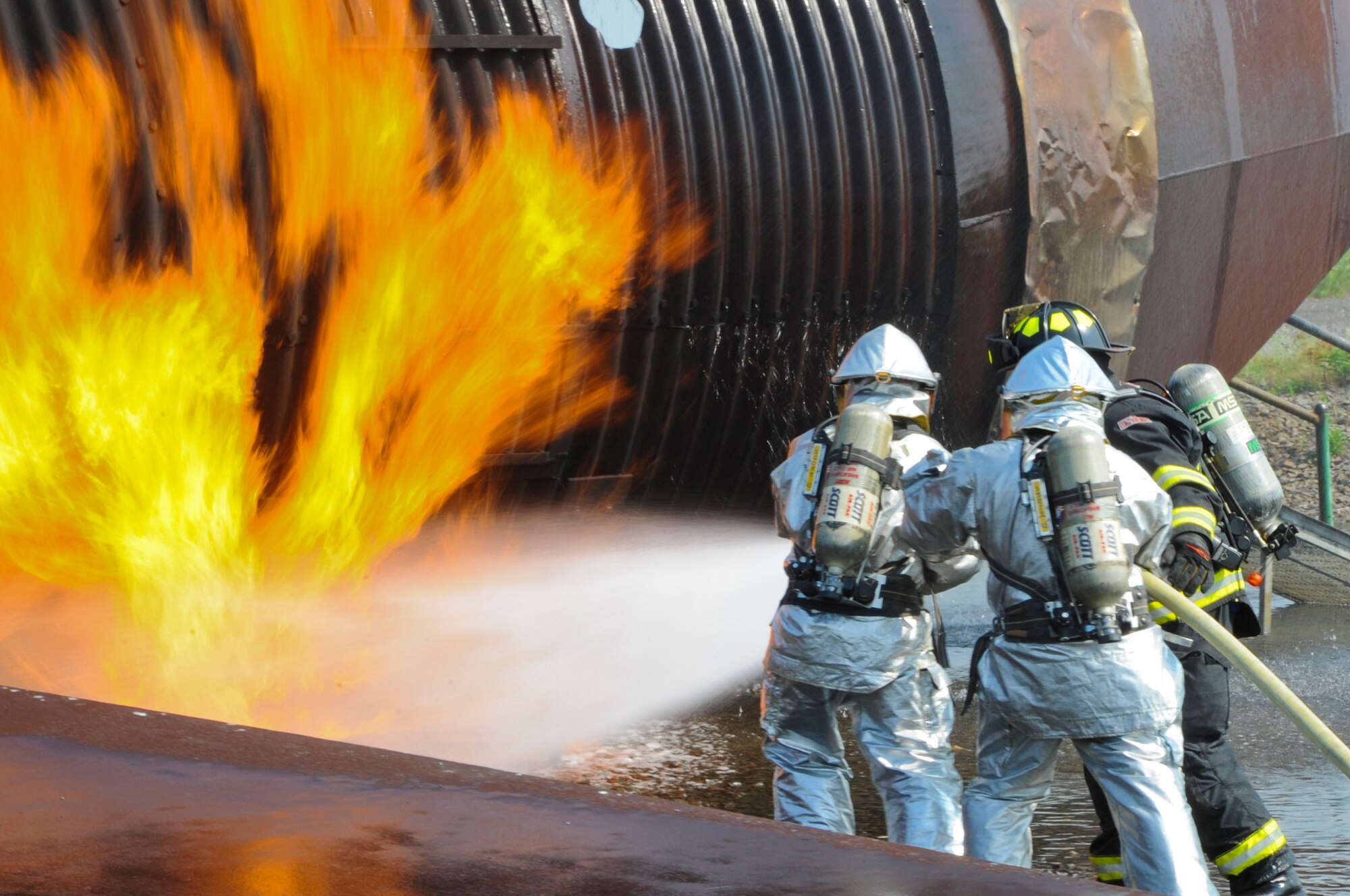 Airmen and Marines fight a fire near the rear of a training aircraft June 10, 2011, during a joint firefighting course at Joint Base McGuire-Dix-Lakehurst, N.J. (U.S. Air Force photo/Airman 1st Class Dennis Sloan)
