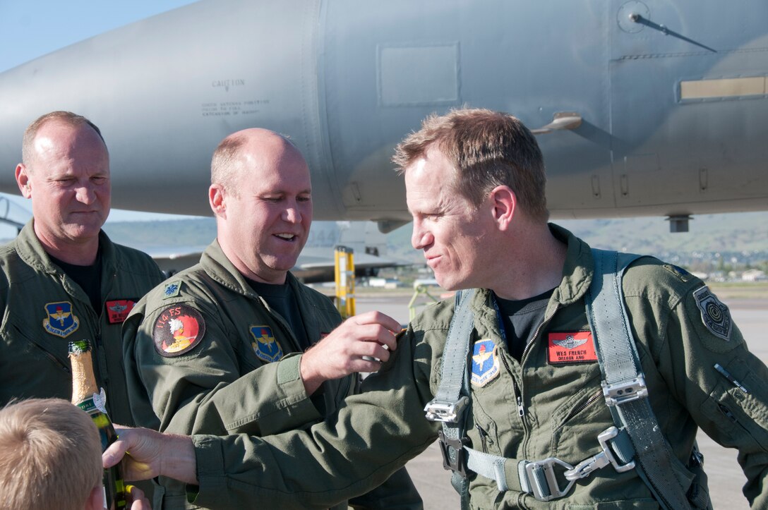 Lt. Col. Whit Sieben, 114th Fighter Squadron Commander, places a 3,000 hour patch on  Lt. Col. Wes "Pappy" French, 173rd Fighter Wing Chief of Safety, after French's 3,000 hour flight June 8, 2011 at Kingsley Field, Klamath Falls, Ore.  (U.S. Air Force Photo by Tech. Sgt Jennifer Shirar) RELEASED