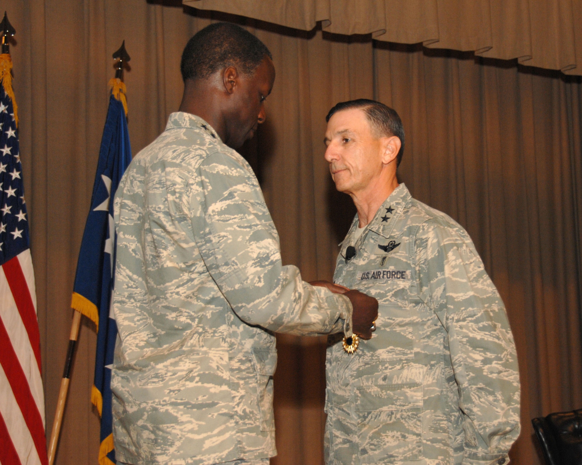 Gen. Edward A. Rice Jr., commander of the Air Education and Training Command, presents the Air Force Distinguished Service Medal to Maj. Gen. Byron C. Hepburn, commander, 59th Medical Wing, Jun 16 at Wilford Hall Medical Center, Lackland Air Force Base, Texas. General Hepburn was noted for his exceptional meritorious service in a duty of great responsibility while serving as the commander of the Air Force Medical Suppport Agency, Bolling Air Force Base, and deputy surgeon general, Office of the Surgeon General from Sept. 5, 2008 to Nov. 5 2010.  (U.S. Air Force Photo/Staff Sgt. Josie Walck)