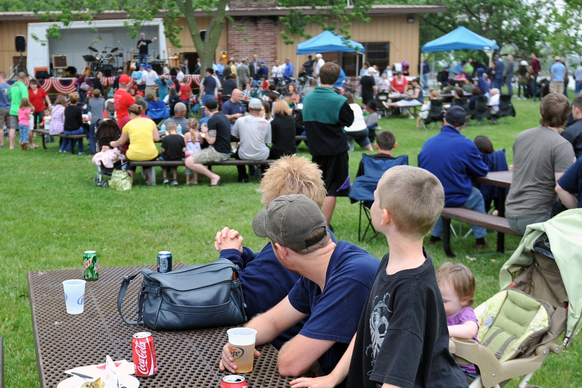 Patrons wait anxiously for entertainment to start at the Offutt Advisory Council's Annual Offutt Appreciation Picnic June 10, 2011 at the Offutt Air Force Base, Neb., Base Lake. Team Offutt employees and their families enjoyed a day in the sun that included free food, beverages and entertainment during the event. (U.S. Air Force photo by Jeff W. Gates/Released)