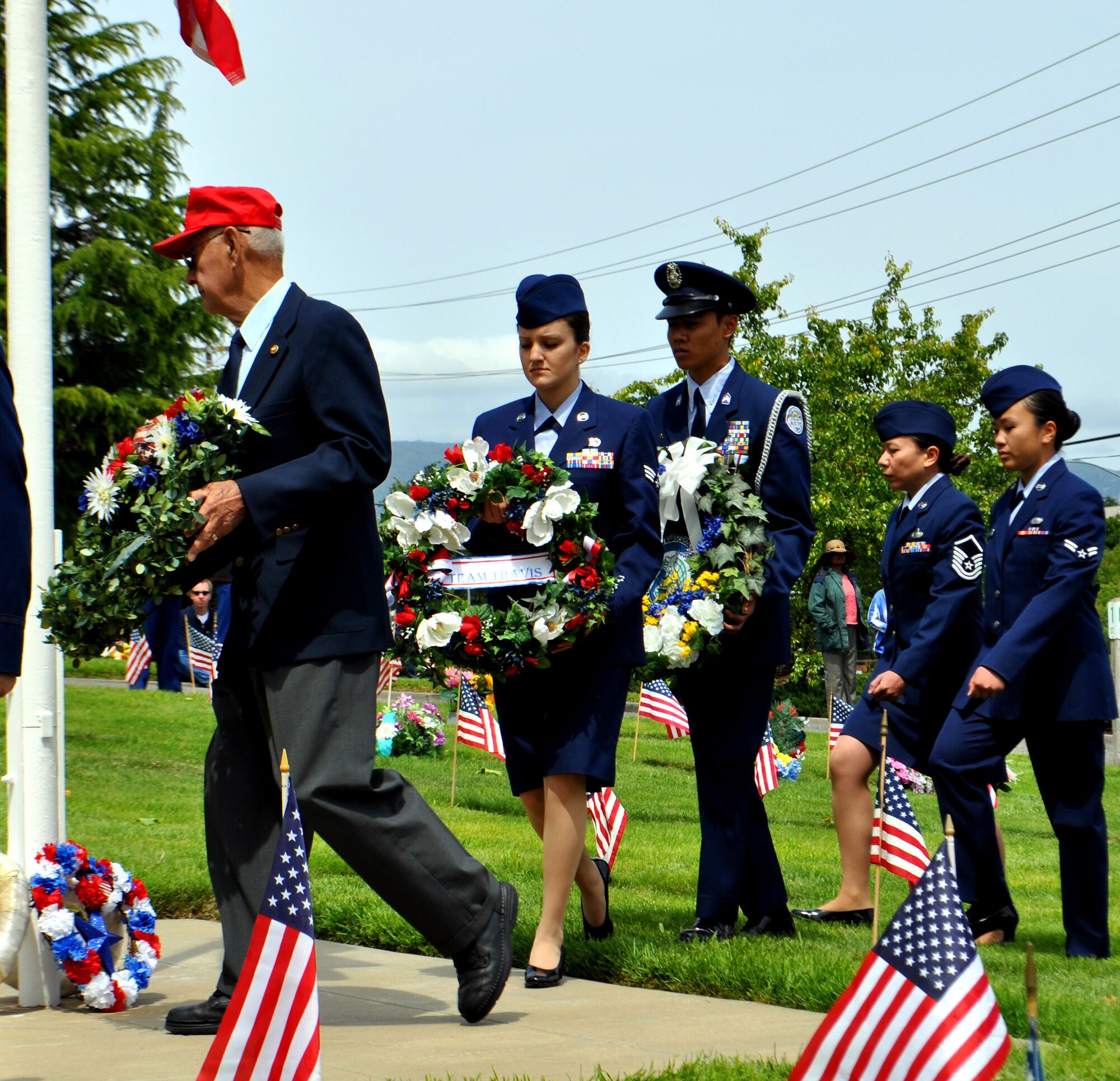 TRAVIS AIR FORCE BASE, Calif. -- Senior Amn. Jessica Knight (center) lays the Team Travis wreath at the Vacaville/Elmira Cemetery on Memorial Day 2011. (U.S. Air Force photo/Senior Master Sgt. Ellen L. Hatfield).  
