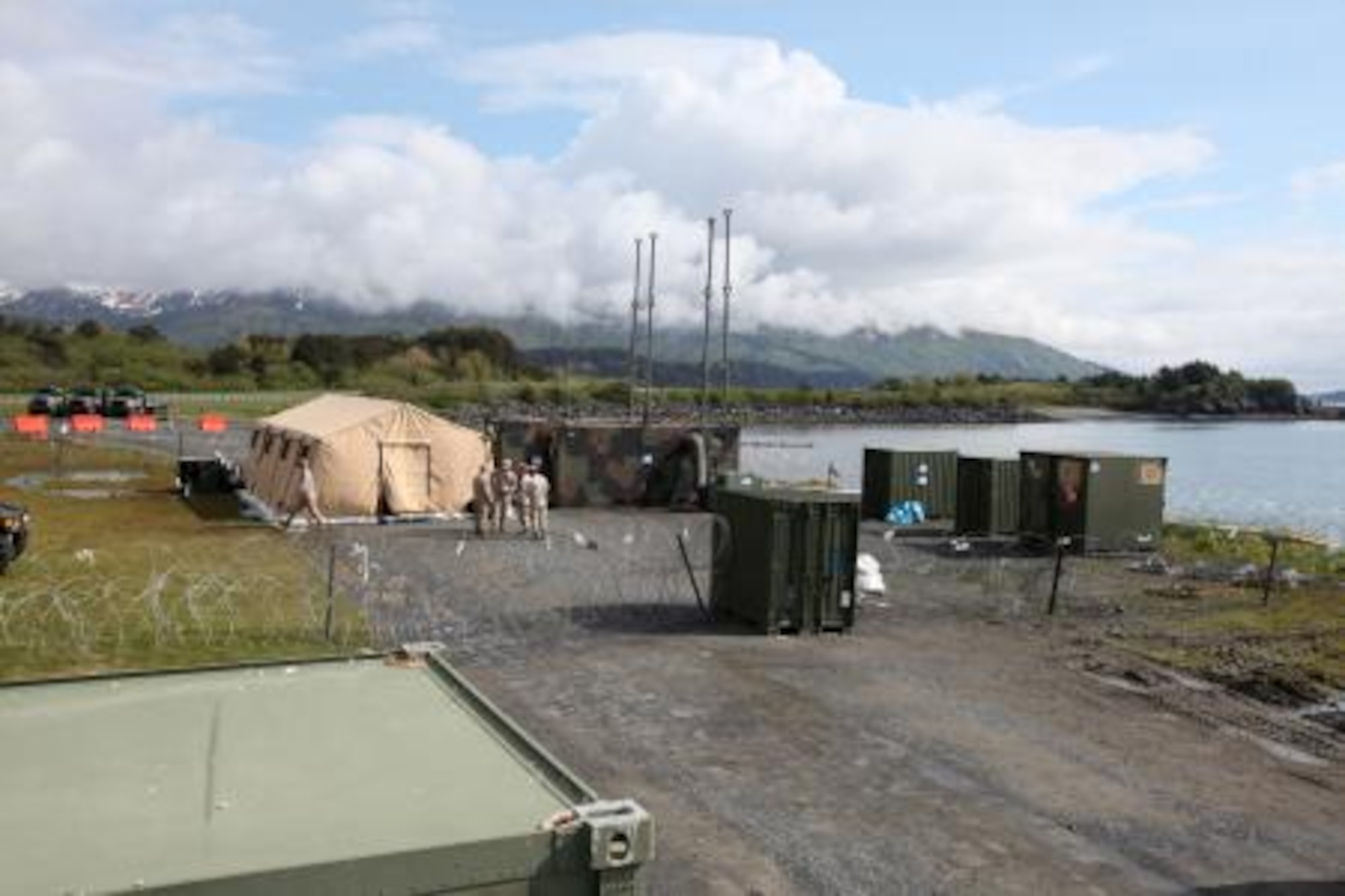 Marines assigned to Marine Air Control Squadron-1 discuss their participation in Exercise Northern Edge 11 at a three-dimensional air defense radar and communication satellite site here June 14, 2011. Soldiers from Company C 307, 59th Signal Battalion at Joint Base Elmendorf-Richardson, Alaska, helped the Marines set up the site. (Photo by Marine Cpl. Marionne T. Mangrum) 