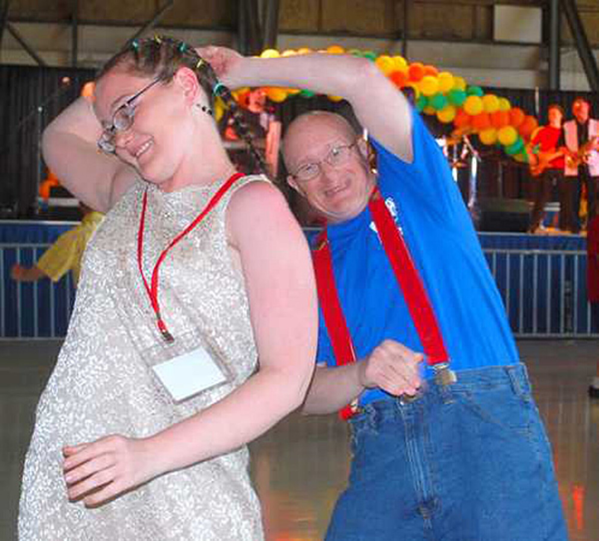 John Stefenson swings Tabitha Miller during the Victory Dance in Hangar 1 at McChord Field, Wash., June 4; during the Special Olympics Washinngton. More than 3,000 athletes came to the dance to have fun and celebrate their athletic accomplishments. Reservists with the 446th Airlift Wing played a key role in organizing the Victory Dance and other events. (U.S. Army photo by Ingrid Barrentine)