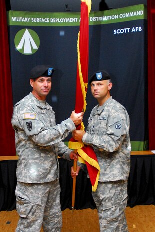 Army Lt. Col. Robert Dawson (right) receives the 841st Transportation Battalion guidon from Col. Jeffrey Helmick during the 841st Transportation Battalion change of command ceremony at Joint Base Charleston June 16. Colonel Dawson assumed the command from outgoing commander Col. Ines White. The passing of the unit colors represents continuity by symbolizing the orderly transition of a command from one officer to another. Colonel Helmick is the 597th Transportation Brigade commander. (U.S. Navy photo/Machinist's Mate 3rd Class Brannon Deugan)