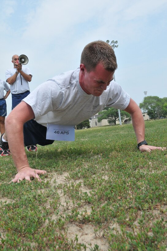 Staff Sgt. Coban Goertz, 46th Aerial Port Squadron load planner, performs push-ups June 12, 2011, as part of the wing's first Fitness Challenge at the track, Dover Air Force Base, Del. The 46th APS team beat seven other teams for the championship trophy. (U.S. Air Force photo by Staff Sgt. Andria J. Allmond)