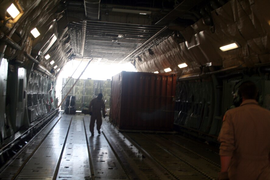Air transportation Airmen off-load cargo from a C-5M Super Galaxy from Dover Air Force Base, Del., at Bagram Airfield, Afghanistan, on June 6, 2011. The C-5M's mission to Bagram was to complete the first Arctic overflight from Dover AFB to Bagram Airfield. The plane successfully landed at Bagram in just over 15 hours on June 6, 2011, then picked up cargo for the return trip back to the United States. (U.S. Air Force Photo/Master Sgt. Scott T. Sturkol)