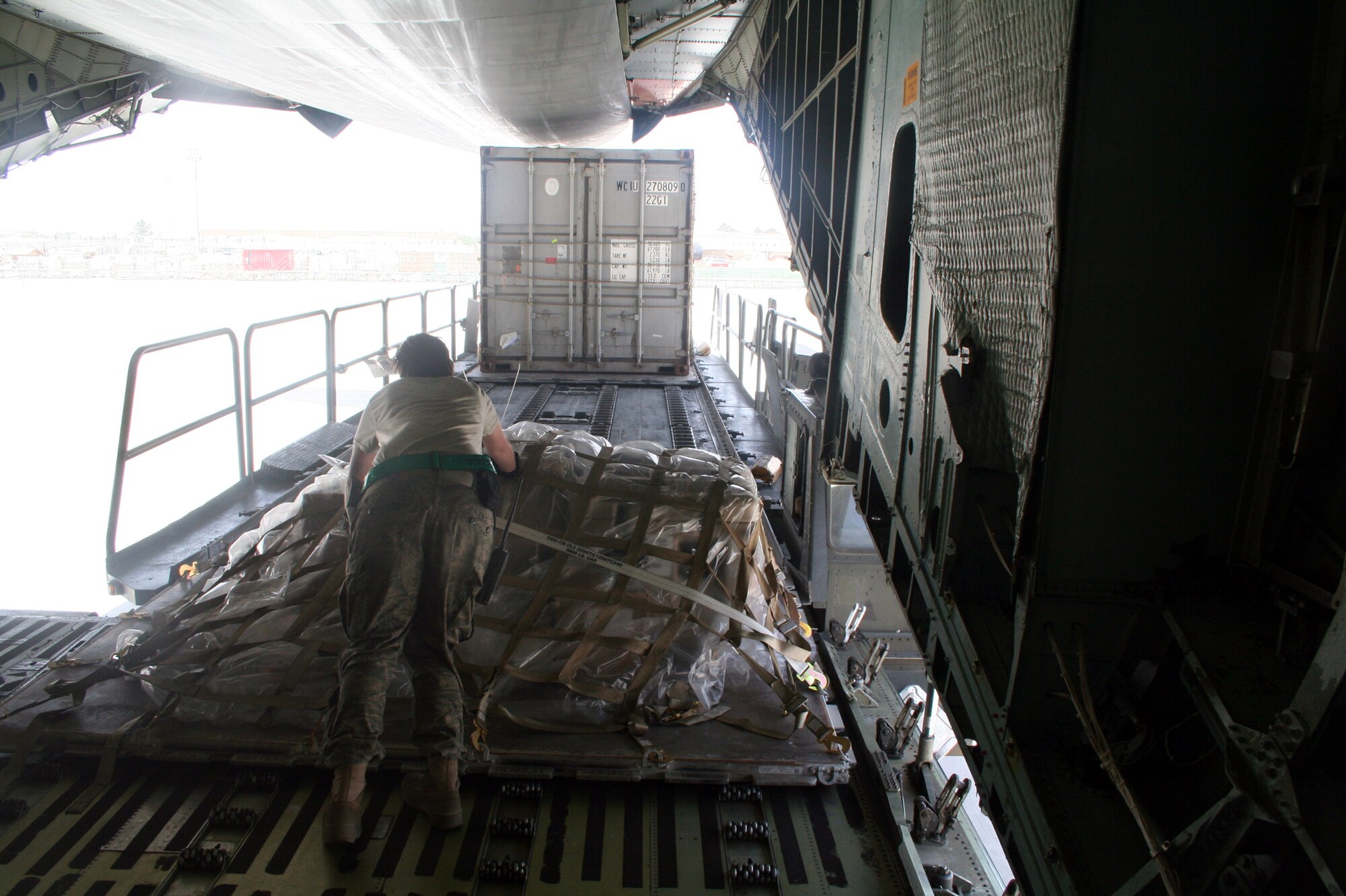 Air transportation Airmen off-load cargo from a C-5M Super Galaxy from Dover Air Force Base, Del., at Bagram Airfield, Afghanistan, on June 6, 2011. The C-5M's mission to Bagram was to complete the first Arctic overflight from Dover AFB to Bagram Airfield. The plane successfully landed at Bagram in just over 15 hours on June 6, 2011, then picked up cargo for the return trip back to the United States. (U.S. Air Force Photo/Master Sgt. Scott T. Sturkol)