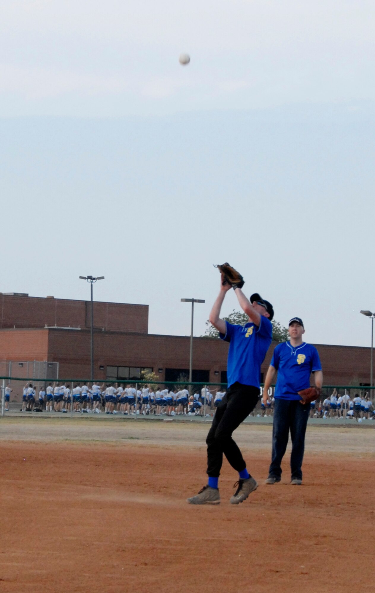 GOODFELLOW AIR FORCE BASE, Texas -- 1st Responders' first baseman Jeremy Davis catches a pop fly for an easy out during the 2011 Base Intramural Softball Championship game June 15.  The 17th Security Forces Squadron 1st Responders' defeated the 17th Training Support Squadron Tigers two games to one, bringing home this year's Championship title.  (U.S. Air Force photo/Connie Hempel)