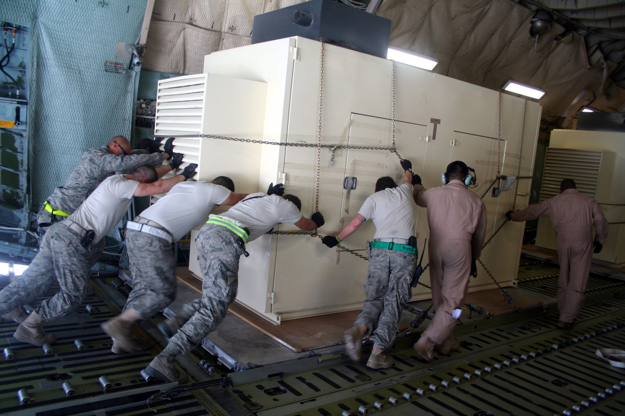 Air transportation Airmen load a C-5M Super Galaxy from Dover Air Force Base, Del., with cargo at Bagram Airfield, Afghanistan, on June 5, 2011. The C-5M's mission to Bagram was to complete the first Arctic overflight from Dover AFB to Bagram Airfield. The plane successfully landed at Bagram in just over 15 hours on June 6, 2011, then picked up cargo for the return trip back to the United States. (U.S. Air Force Photo/Master Sgt. Scott T. Sturkol)