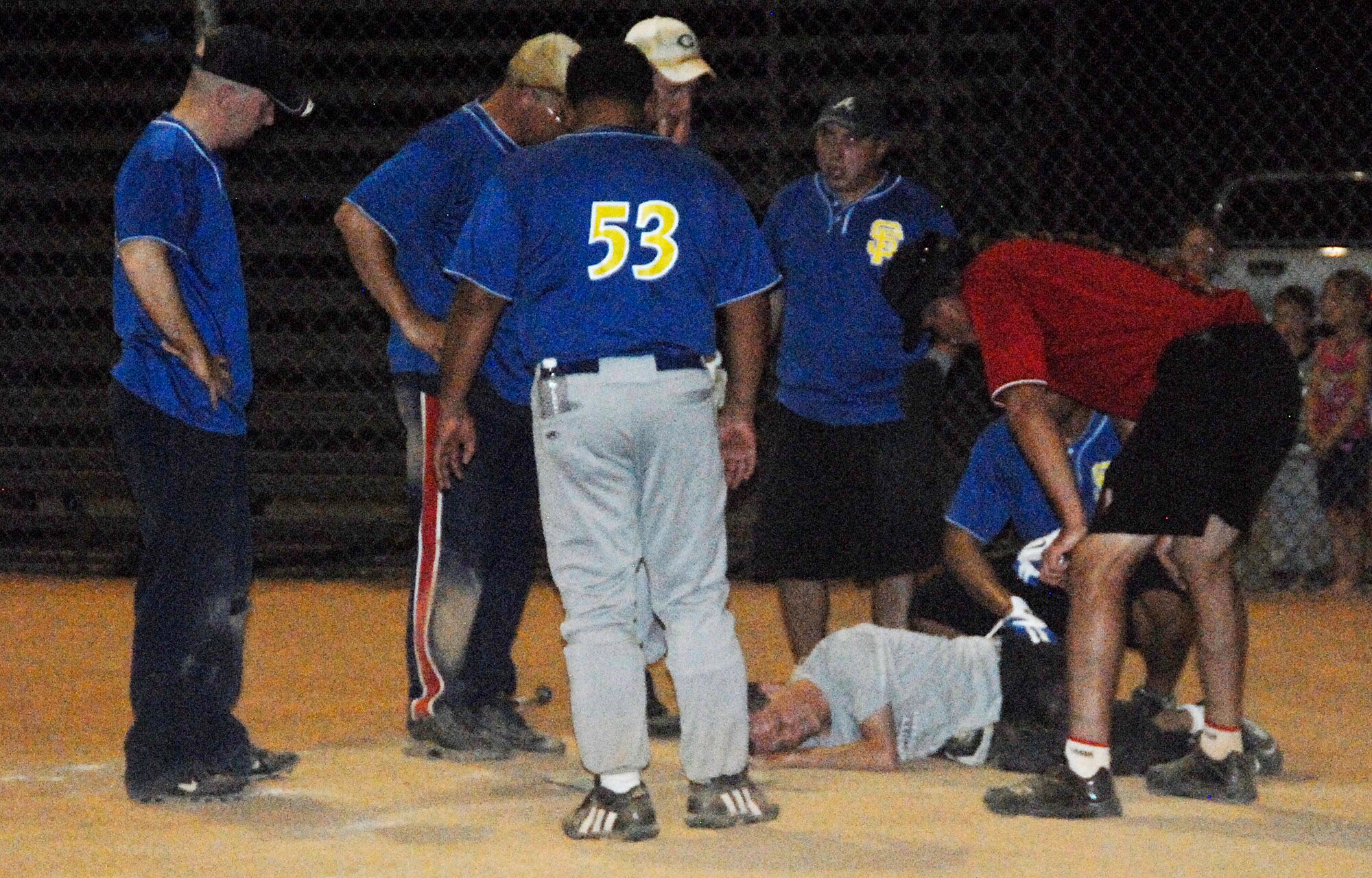 GOODFELLOW AIR FORCE BASE, Texas -- A 1st Responder goes down during the 2011 Base Intramural Softball Championship game June 15 after leaping over the Tigers' catcher.  Despite the injury during Game 3, which landed the player at a local hospital, the 17th Security Forces Squadron 1st Responders defeated the 17th Training Support Squadron and brought home this year's Championship title.  (U.S. Air Force photo/Connie Hempel)