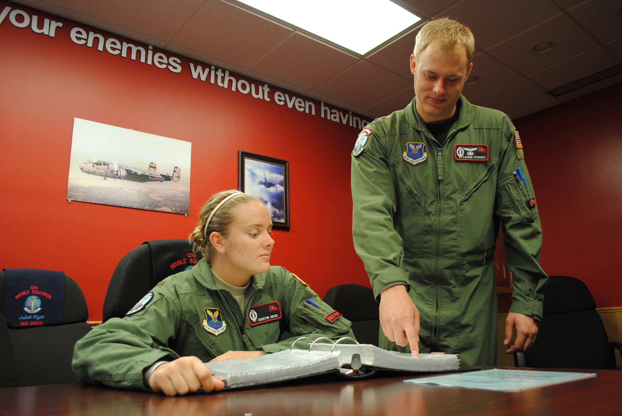 Capt. Lon Schmidt, 12th Missile Squadron ICBM combat crew commander explains to 2nd Lt. Kristin Geisz, 12th MS ICBM crew deputy what to do when there is a fire in a missile capsule. (U.S. Air Force photo/Airman 1st Class Katrina Heikkinen)