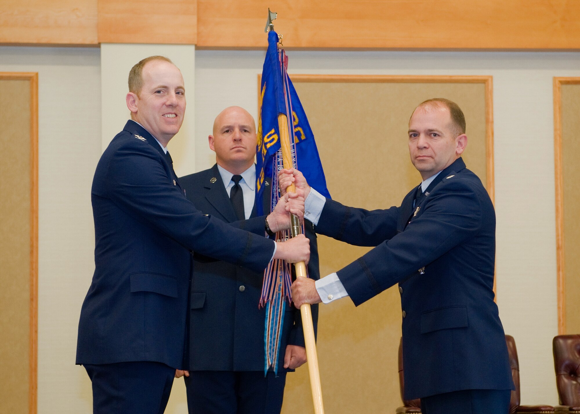 Lt. Col. Craig Ramsey accepts command of the 12th Missile Squadron from Col. Edward Rimback, 341st Operations Group commander, June 13 at the Grizzly Bend. Master Sgt. Robert Baker, 341st Operations Group First Sergeant, looks on. (U.S. Air Force photo/Beau Wade)
