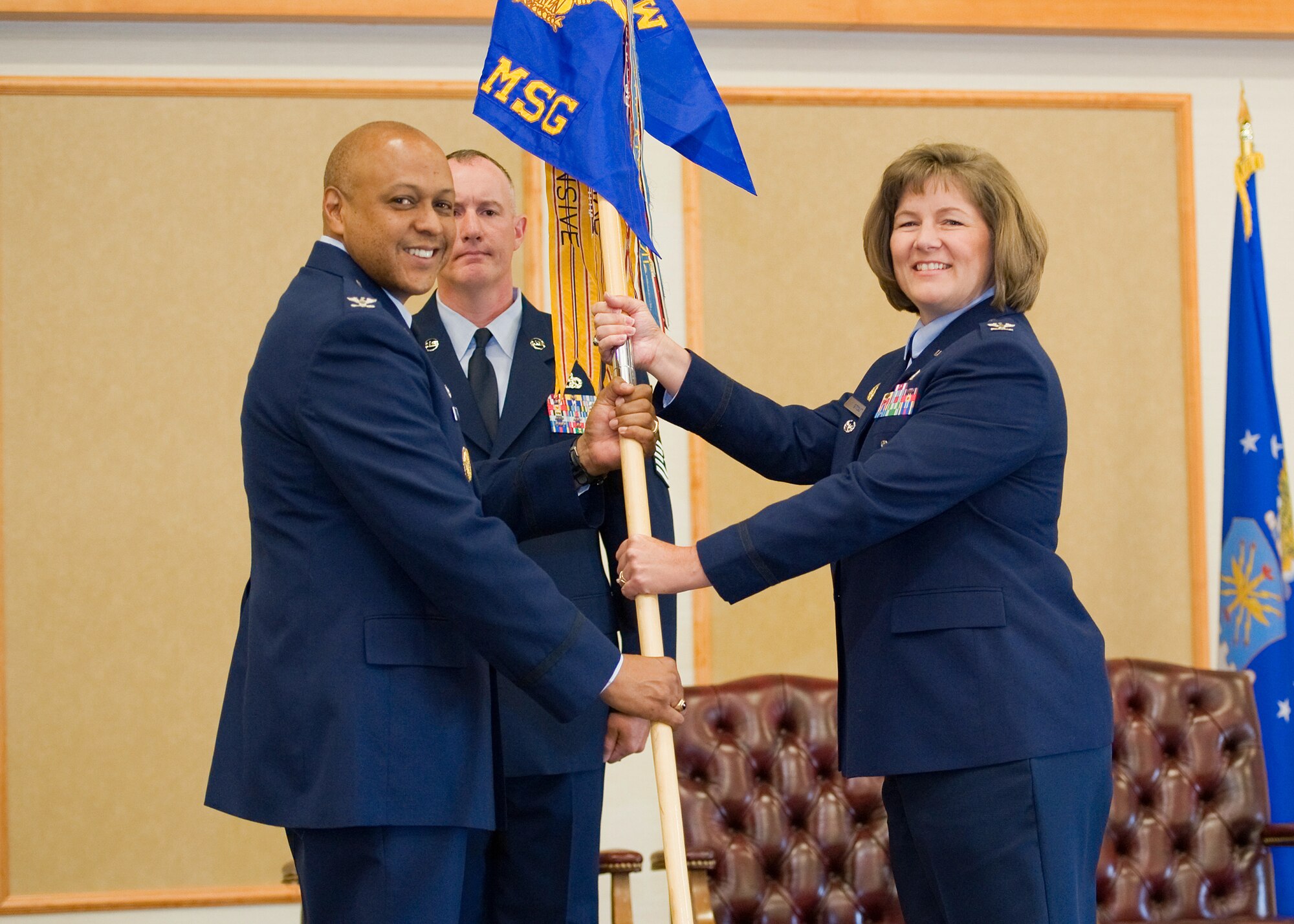 Col. Angela Stout accepts command of the 341st Mission Support Group from Brig. Gen. (Sel) Anthony Cotton, 341st Missile Wing commander, June 10 at the Grizzly Bend. Chief Master Sgt. William Valenti, 341st Mission Support Group Superintendent, looks on. (U.S. Air Force photo/Beau Wade)