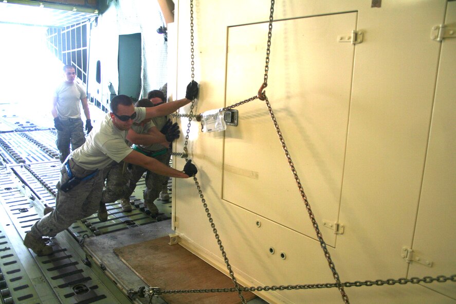 Air transportation Airmen load a C-5M Super Galaxy from Dover Air Force Base, Del., with cargo at Bagram Airfield, Afghanistan, on June 5, 2011. The C-5M's mission to Bagram was to complete the first Arctic overflight from Dover AFB to Bagram Airfield. The plane successfully landed at Bagram in just over 15 hours on June 6, 2011, then picked up cargo for the return trip back to the United States. (U.S. Air Force Photo/Master Sgt. Scott T. Sturkol)