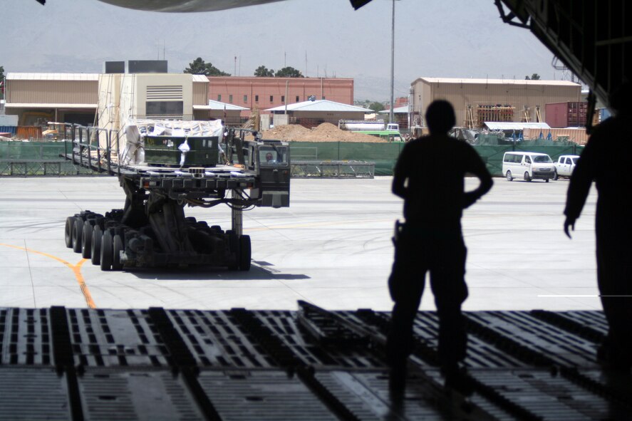 Air transportation Airmen load a C-5M Super Galaxy from Dover Air Force Base, Del., with cargo at Bagram Airfield, Afghanistan, on June 5, 2011. The C-5M's mission to Bagram was to complete the first Arctic overflight from Dover AFB to Bagram Airfield. The plane successfully landed at Bagram in just over 15 hours on June 6, 2011, then picked up cargo for the return trip back to the United States. (U.S. Air Force Photo/Master Sgt. Scott T. Sturkol)