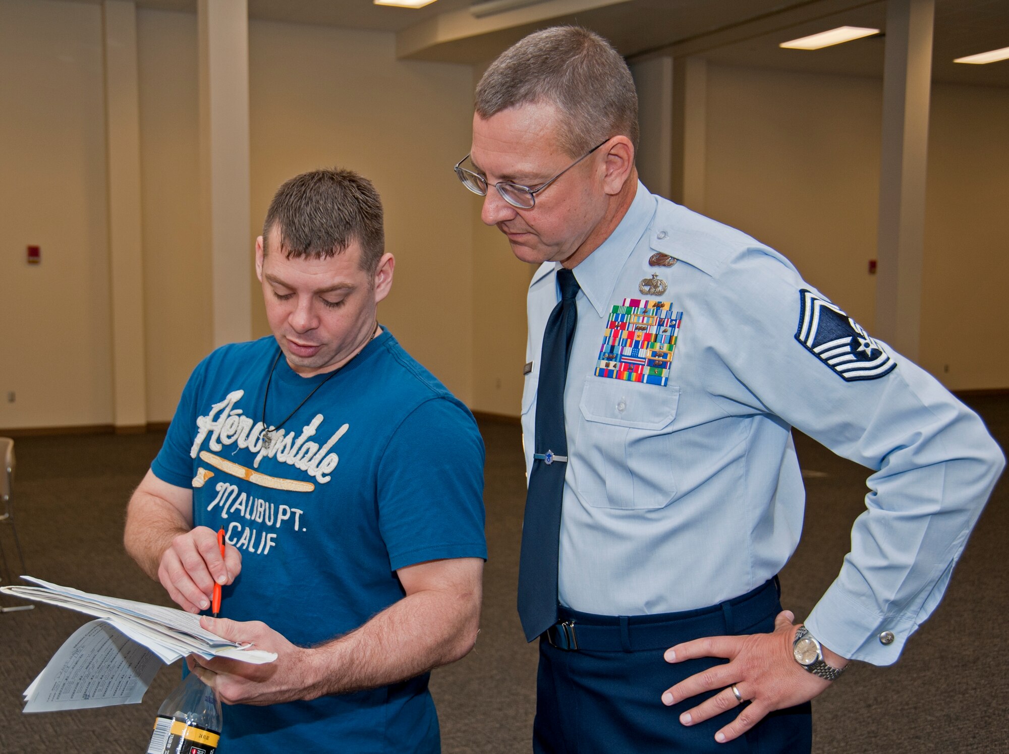 Staff Sgt. Robert Darragh, an Inactive Ready Reservist from Pensacola, Fla., goes over paperwork with Senior Master Sgt. David Beach, 403rd Wing chief of recruiting, and discusses possibilities of becoming an active Reservist.  (U.S. Air Force photo by Dhiana McKaig)
