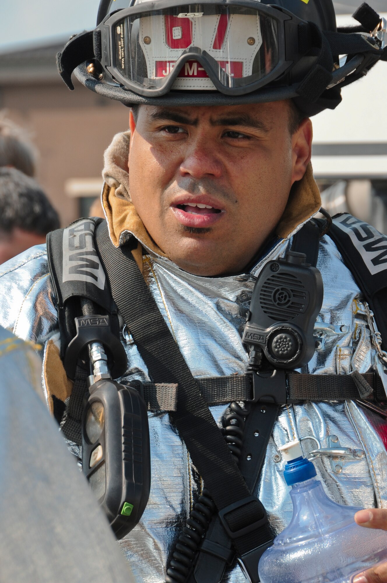Ismael Alicea, Joint Base McGuire-Dix-Lakehurst Fire Department crew chief, hydrates before he extinguishes multiple fires on a training aircraft here June 10. The JB MDL FD joined forces with reservist from the Marine Wing Support Squadron 472 successfully extinguishing fires that engulfed two engines of a mock aircraft trainer. Firefighters wear more than 60 pounds of insulated gear while battling the fires, so hydration is essential for them not to overheat. (U.S. Air Force photo by Airman 1st Class Dennis Sloan/Released)