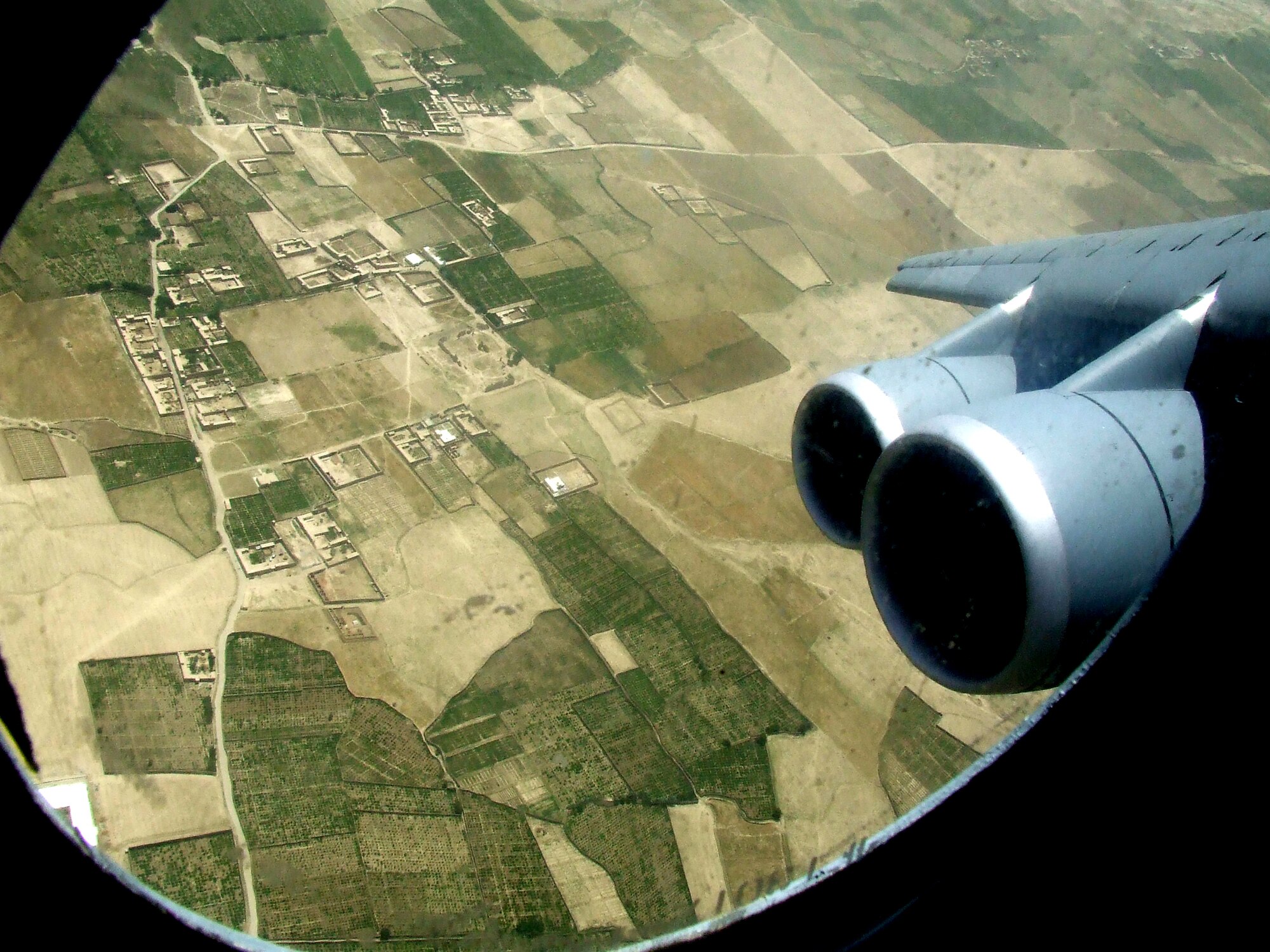 The countryside of Afghanistan can be seen through the window of a C-5M Super Galaxy during an airlift mission on June 6, 2011.  The C-5M was on the first direct delivery airlift mission that went through the Arctic Circle from Dover Air Force Base, Del., to Bagram Airfield, Afghanistan, between June 5-6, 2011. (U.S. Air Force Photo/Master Sgt. Scott T. Sturkol)