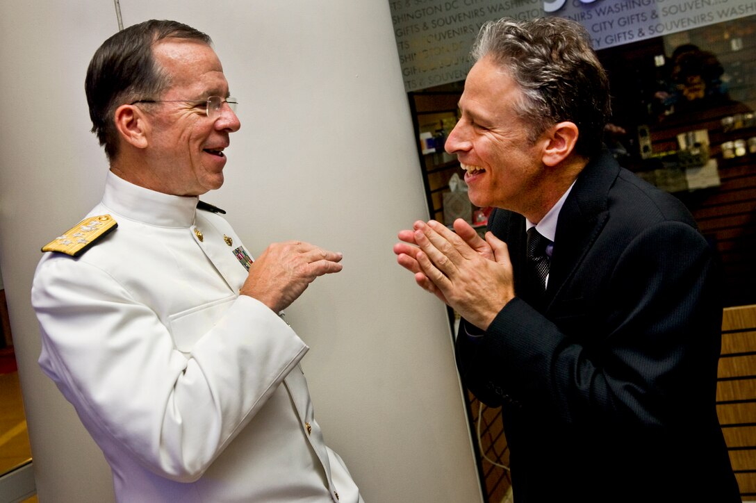 Navy Adm. Mike Mullen, chairman of the Joint Chiefs of Staff, speaks with Jon Stewart of "The Daily Show with Jon Stewart" at the Stand Up for Heroes dinner in Washington, D.C., June 16, 2011. 