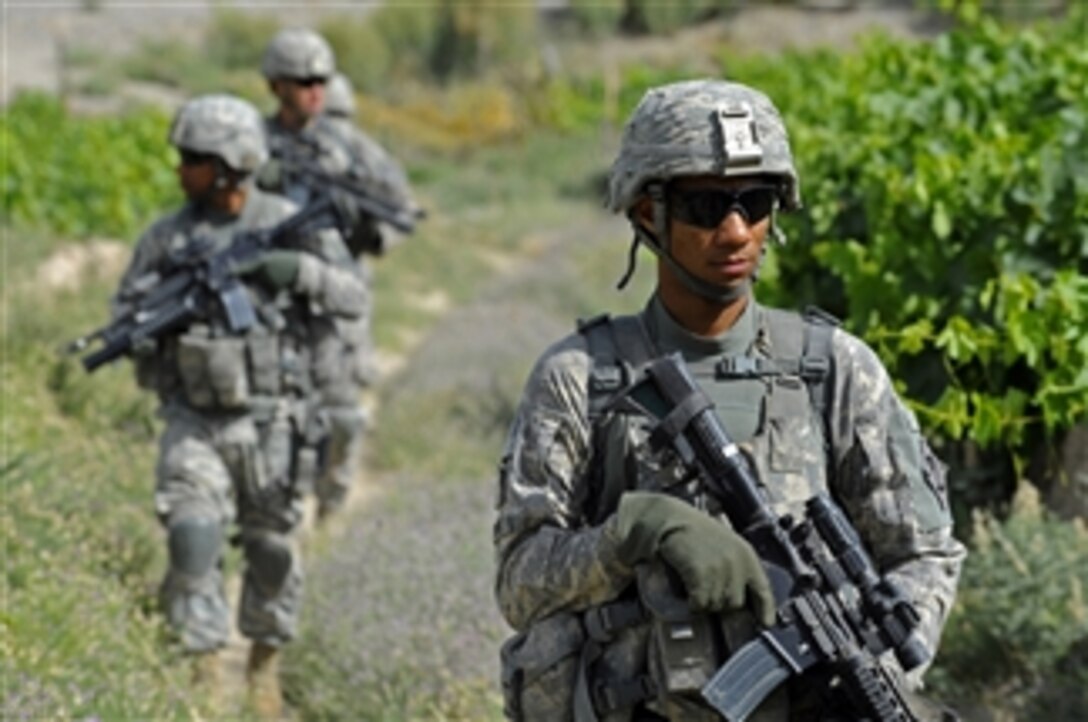 U.S. Army Spc. Daishon Newton, assigned to the Zabul Provincial Reconstruction Team security force, provides security as members of the team make their way to a canal project site in Zabul province, Afghanistan, on June 14, 2011.  