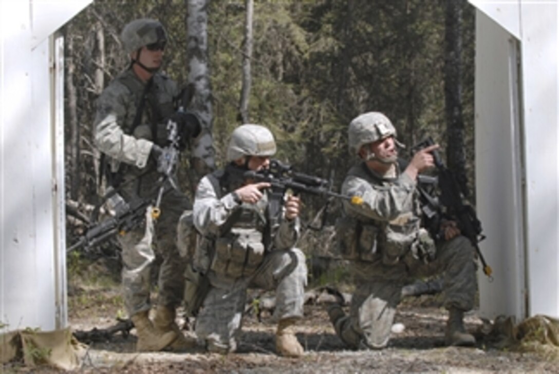 Senior Airman Payton Barnes (left), Airman 1st Class Stephen Becker and Staff Sgt. John Szewzyk (right) come under simulated fire during a village sweep as part of an exercise at Joint Base Elmendorf-Richardson, Alaska, on May 24, 2011.  The three airmen are assigned to the 673rd Security Forces Squadron.  