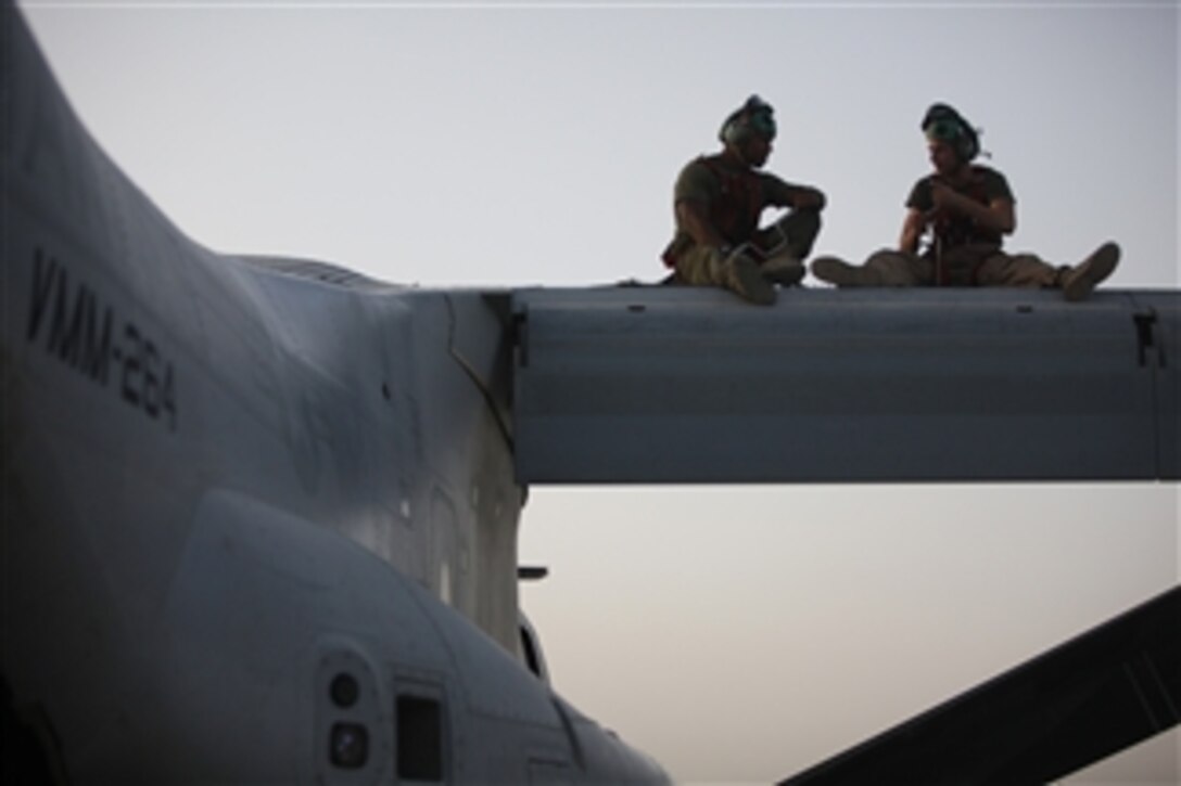 Lance Cpl. Isaiah Long (left) and Sgt. Paul Shutts perform maintenance on an MV-22B Osprey aircraft at Camp Bastion, Afghanistan, on June 16, 2011.  Both Long and Shutts are Osprey avionics technicians with Marine Medium Tiltrotor Squadron 264.  