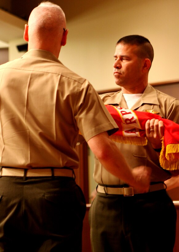 Master Gunnery Sgt. Jeffery A. Schertz, senior enlisted advisor, Marine Individual Reserve Support Organization, retires the Marine Corps Mobilization Command Colors during a deactivation ceremony June 17.  Marine Corps Individual Reserve Support Organization will be based at Marine Corps Support Facility New Orleans and falls under the command of Marine Forces Reserve.