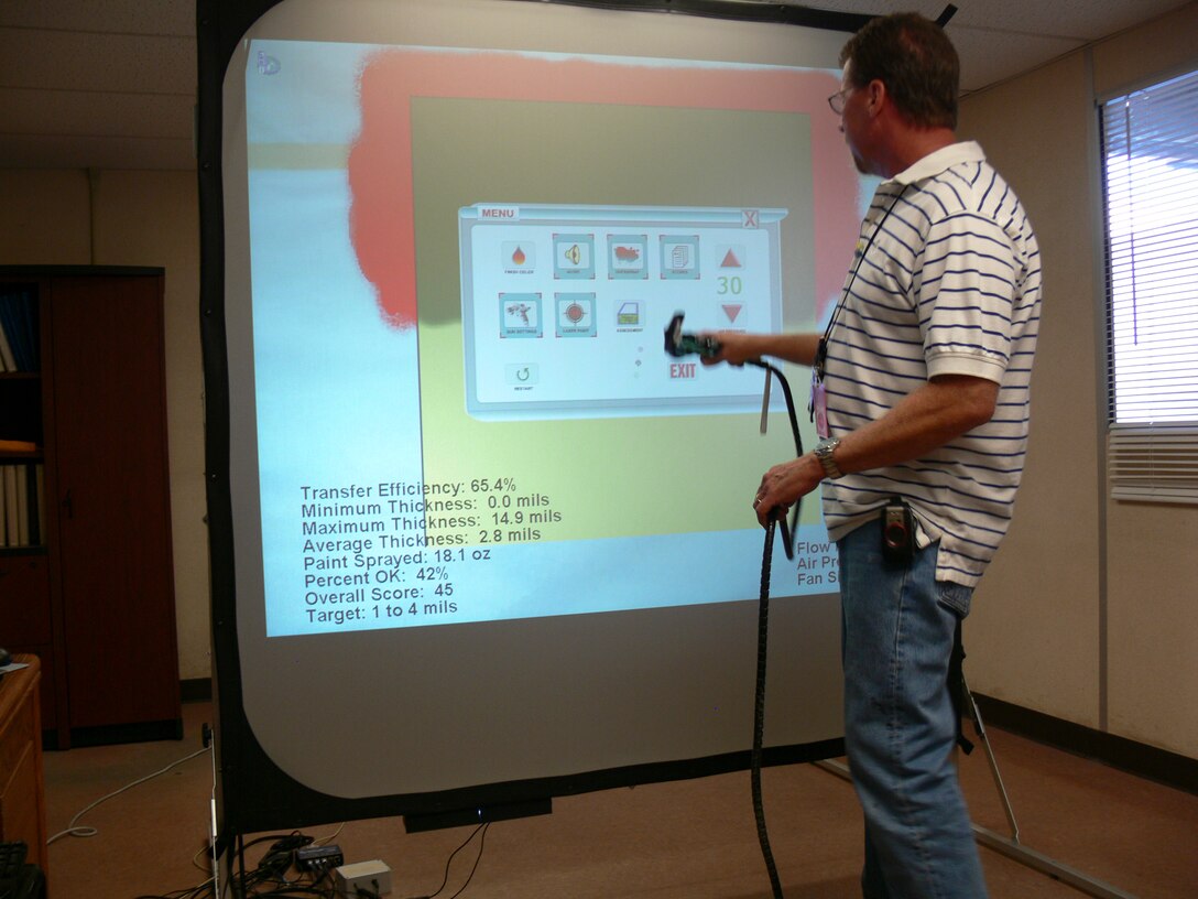 Mike Jackson, supervisor at Cost Work Center-749, demonstrates how the Spray Technique Analysis and Research for Defense Program is used to train and improve employee’s skills as a painter, June 14. The STAR4D Program is used to reduce the amount of waste that would be used in normal training and reduce harmful emissions from the use of the paint booth.