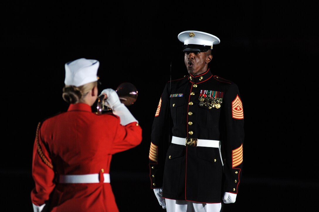 Sgt. Maj. Eric Stockton, Marine Barracks Washington sergeant major, directs the Marine Drum and Bugle Corps' ceremonial bugler to sound the officer's call during a Friday Evening Parade at the Barracks June 17, 2011.