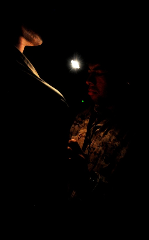 Hospitalman Petty Officer 3rd Class Richard A. Reveles, from Bell Gardens, Calif., checks Marines for medical issues after a helicopter raid on an urban training village here June 16. Reveles serves with India Company, Battalion Landing Team 3/1, the 11th Marine Expeditionary Unit’s ground combat element.