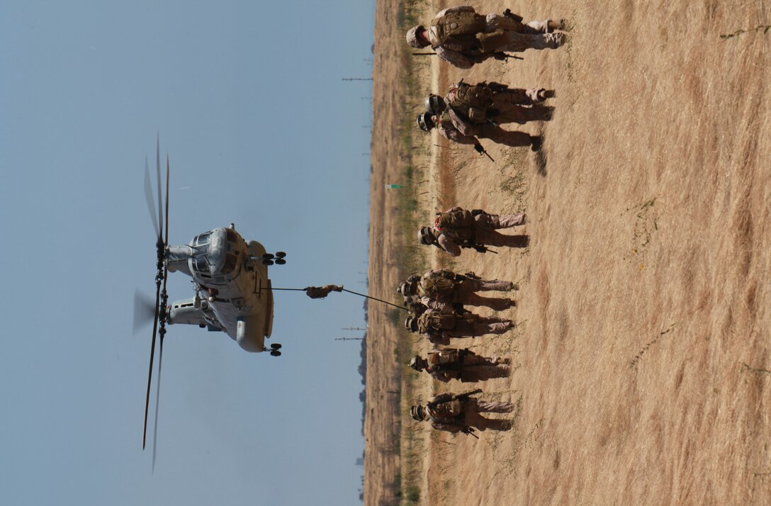 A Marine with the 11th Marine Expeditionary Unit's maritime raid force fast ropes from a CH-46E Sea Knight during an MRF training course June 17. Fast roping is a technique used to quickly descend into a target site without landing the aircraft.::r::::n::::r::::n::::r::::n::