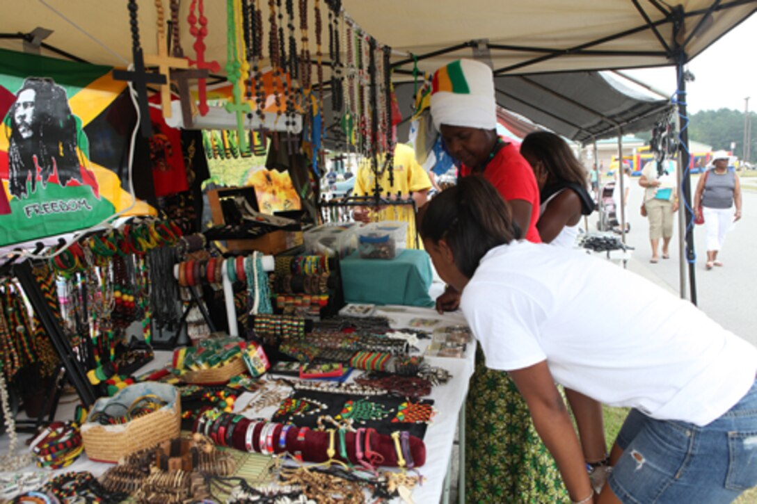 Attendants of the Juneteenth Festival, held at the held at the Jacksonville Commons Recreation Center, browse one of many vendor booths set up at the celebration, June 18. The event was free and open to the public and included live music, dancing, an array of ethnic foods, children's activities, arts and crafts and much more.