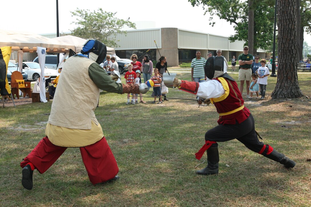 Performers from Barony of Raven’s Cove, the Society of Creative Anachronism dual as patrons watch during the summer reading program’s medieval fair kickoff at the Harriotte B. Smith Library aboard Marine Corps Base Camp Lejeune, June 18. New and exciting events have been added to this year’s SRP, such as guest performances from Flow Circus, magician Jeff Jones and a sandcastle building competition.