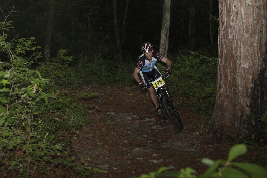 John Lynch, operations officer for Marine Corps Special Operations Command, Marine Corps Base Camp Lejeune, descends into the Piranha Pit bike trails aboard Cherry Point during the annual Marine Corps Community Services Mountain Bike Challenge June 18.