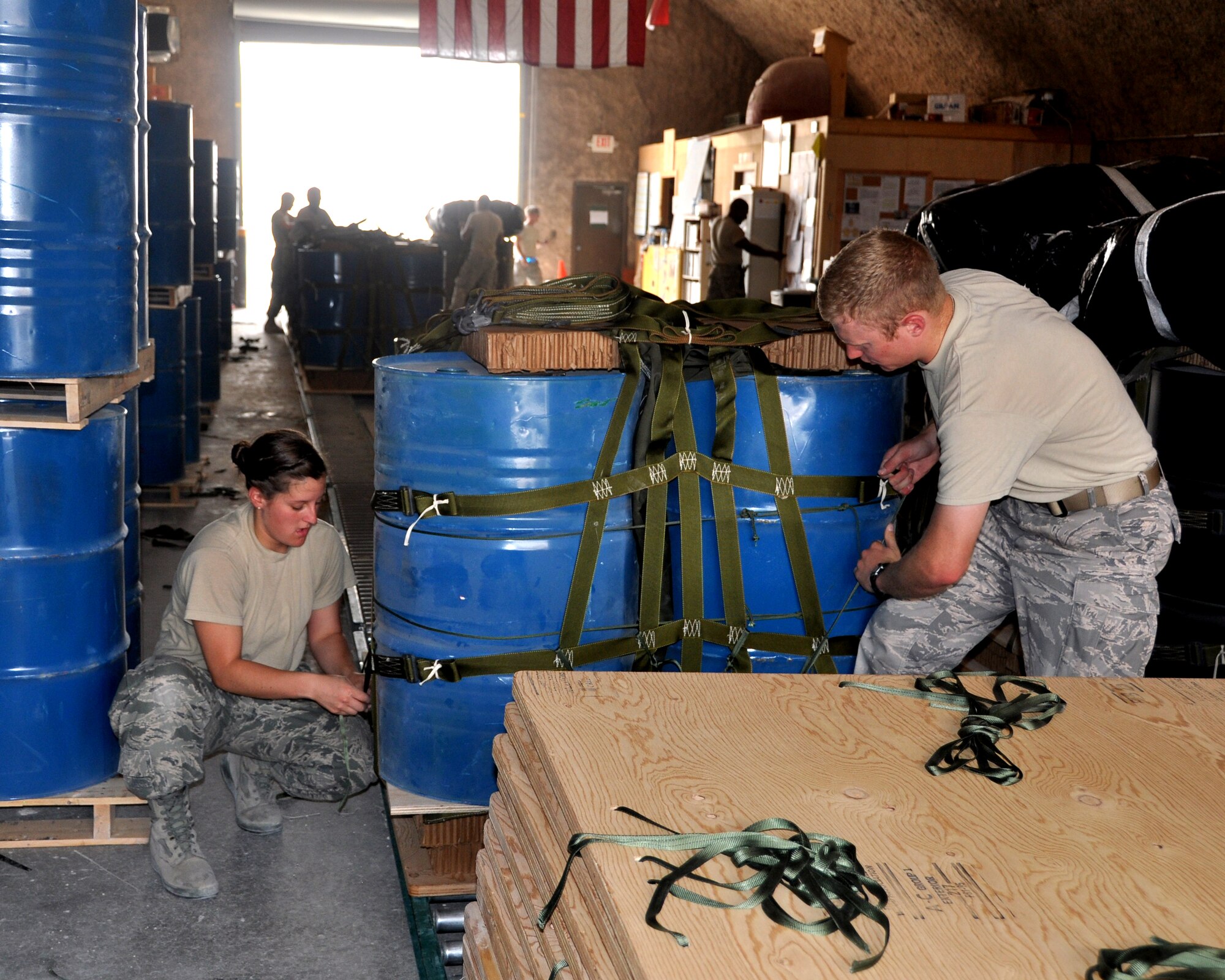 Cadet 2nd Class Erin Doran, United States Air Force Academy Cadet Squadron 22, and Cadet 1st Class Jordan Wittman, USAFA Cadet Squadron 30, work together to expedite the bundling process with U.S. Army Riggers. Cadets Doran and Wittman are here on Dep Ops, a summer program which sends Academy cadets to deployed locations. (U.S. Air Force photo/Cadet 1st Class Shaina Thompson)