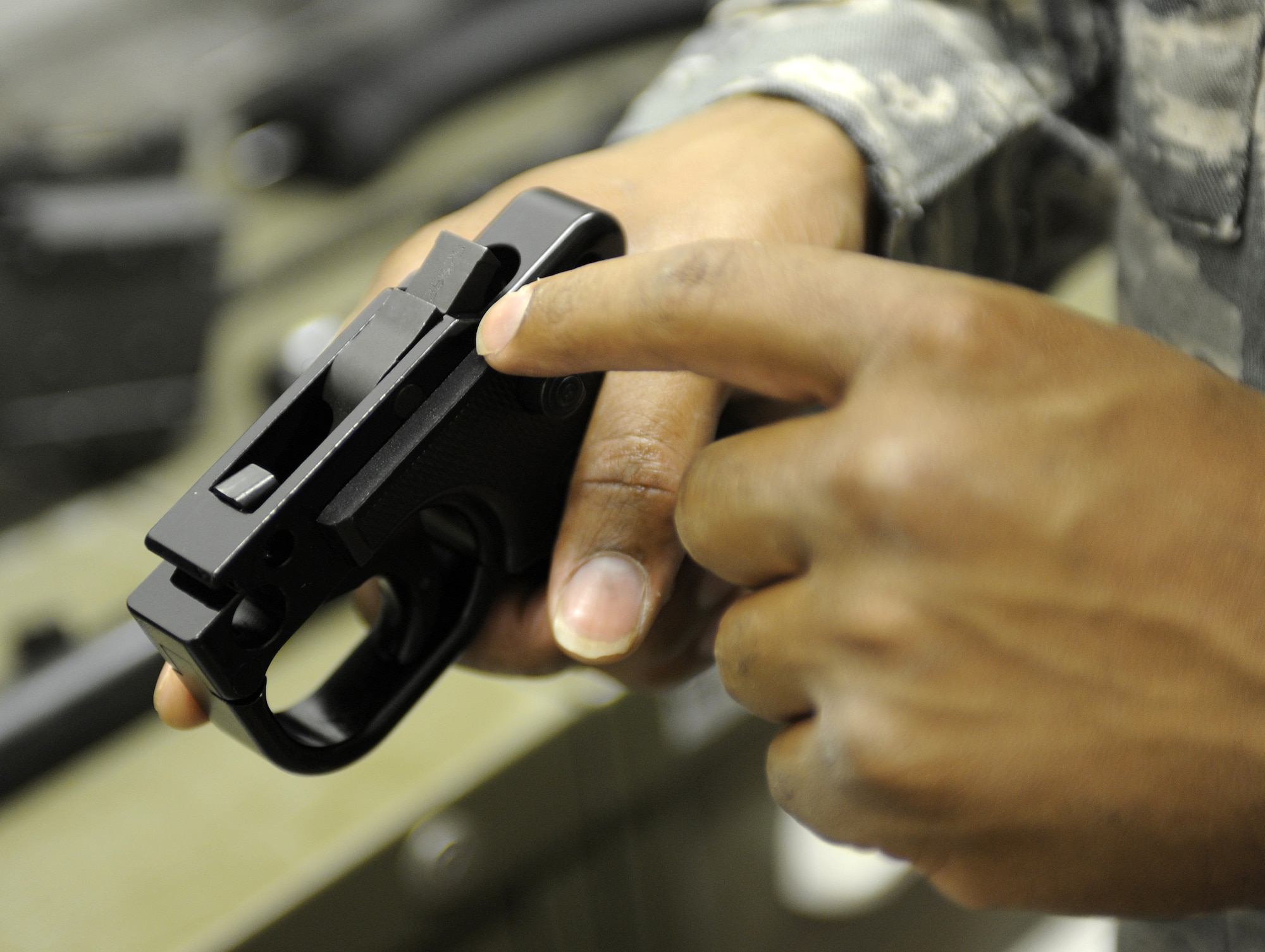 Tech. Sgt. Majid Gayles inspects the sear of an M240 machine gun June 17, 2011, at Kandahar Air Field, Afghanistan. Sergeant Gayles has is performing an initial inspection on the weapon ensuring that it is mission ready. Sergeant Gayles is the NCO in charge of combat arms, training and maintenance and is assigned to the 451st Expeditionary Security Forces Squadron. (U.S. Air Force Photo by Senior Airman Willard E. Grande II)