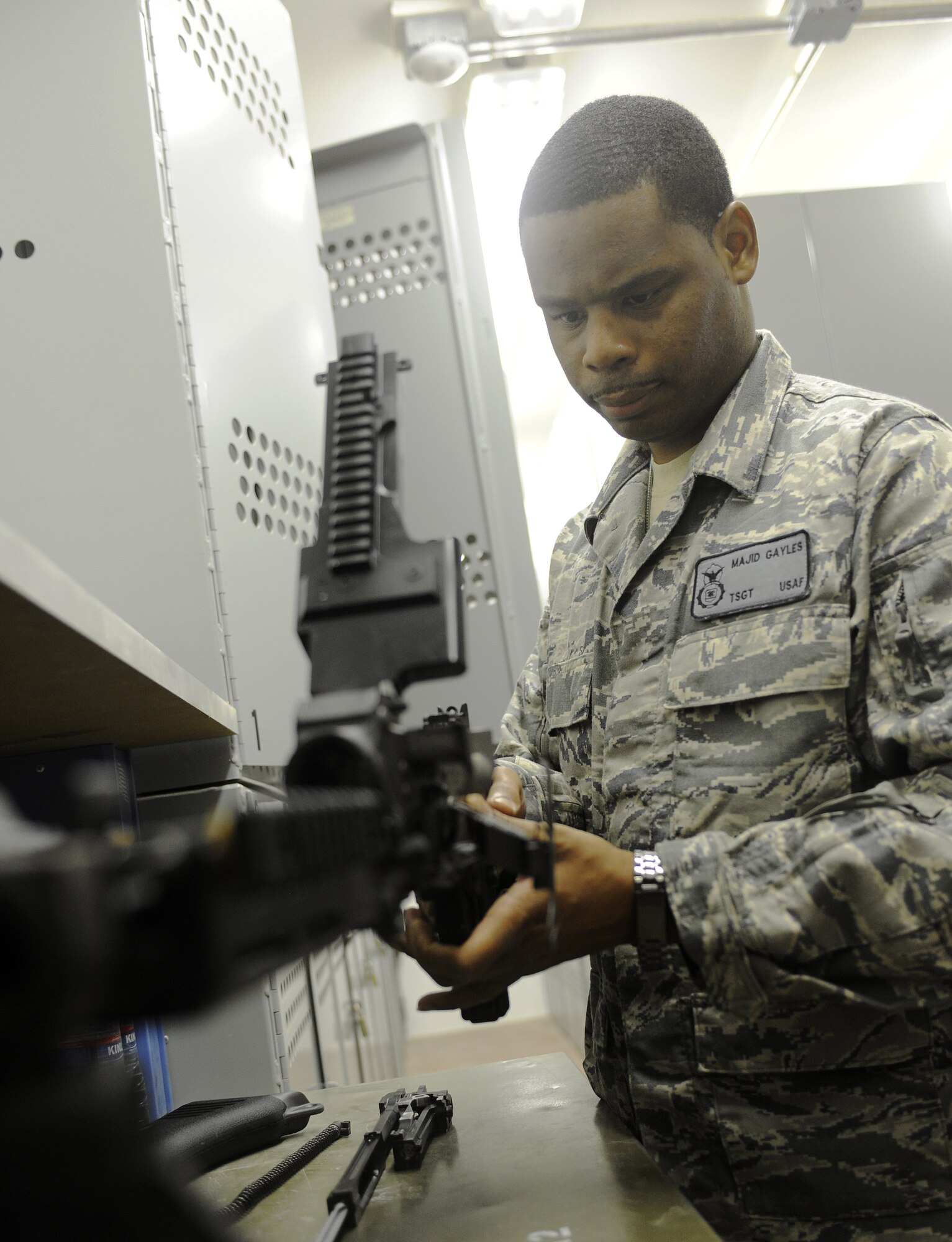 Tech. Sgt. Majid Gayles reassembles an M240 machine gun June 17, 2011, at Kandahar Air Field, Afghanistan. Sergeant Gayles has just done an initial inspection on the weapon ensuring that it is mission ready. Sergeant Gayles is the NCO in charge of combat arms, training and maintenance and is assigned to the 451st Expeditionary Security Forces Squadron. (U.S. Air Force Photo by Senior Airman Willard E. Grande II)