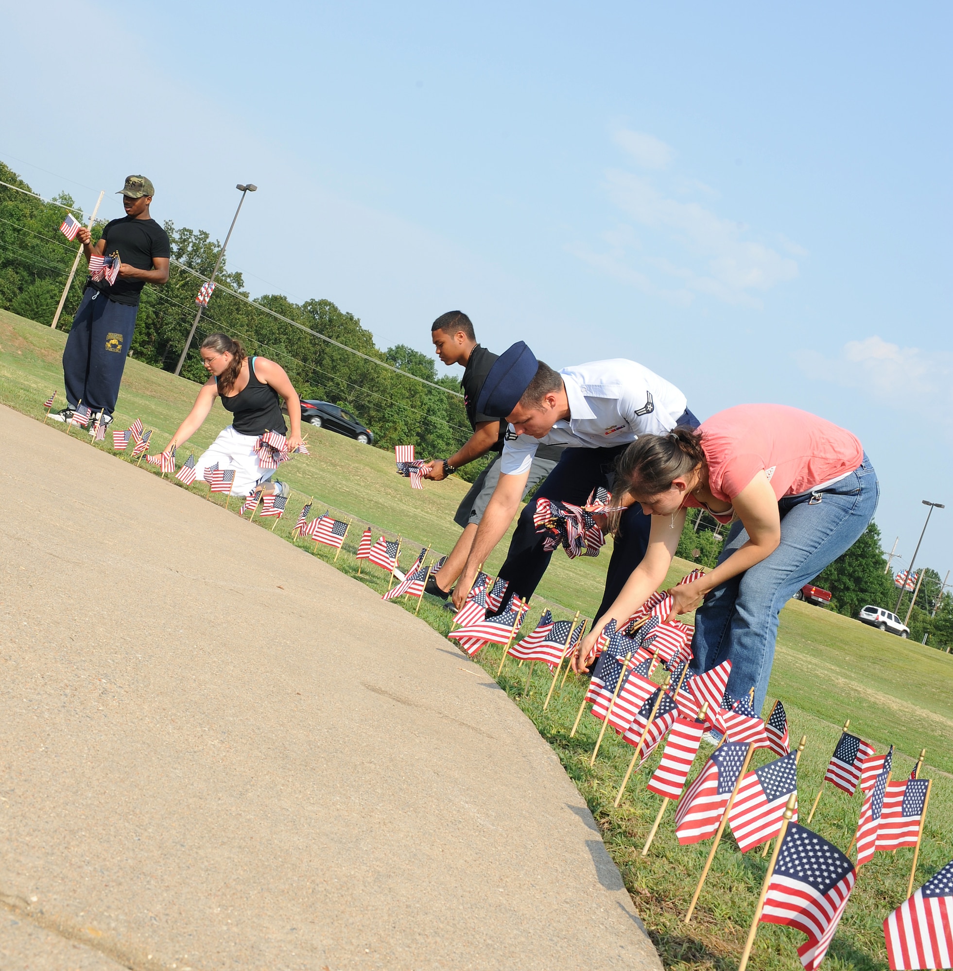 Members from the First Term Airman Center place flags at Heritage Park on June 13, 2011, at Little Rock Air Force Base, Ark. Approximately 1,776 flags were placed for National Flag Day which celebrates the anniversary of the Flag Resolution of 1777. (U.S. Air Force photo by Airman 1st Class Ellora Remington)