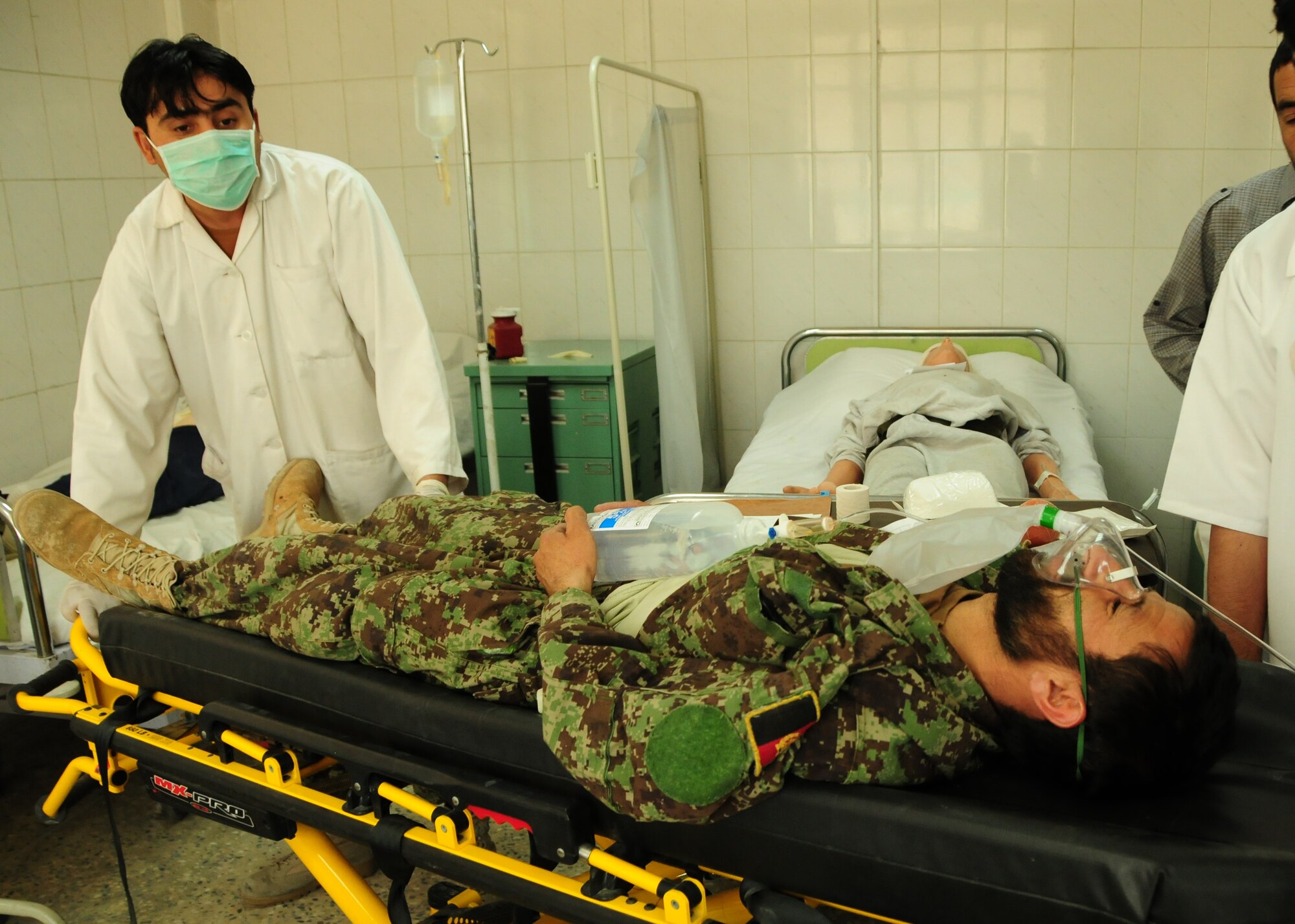 KABUL, Afghanistan -- Medics from the Afghan Air Force respond to a mass casualty training exercise at the Kabul International Airport June 19.  438th Air Expeditionary Wing Airmen initiated the exercise in an effort to evaluate the AAF medics' response, triage and transportation capabilities.  The advisors work shoulder-to-shoulder to train the AAF in an advisory role.  (U.S. Air Force photo by Senior Airman Amber Williams)
