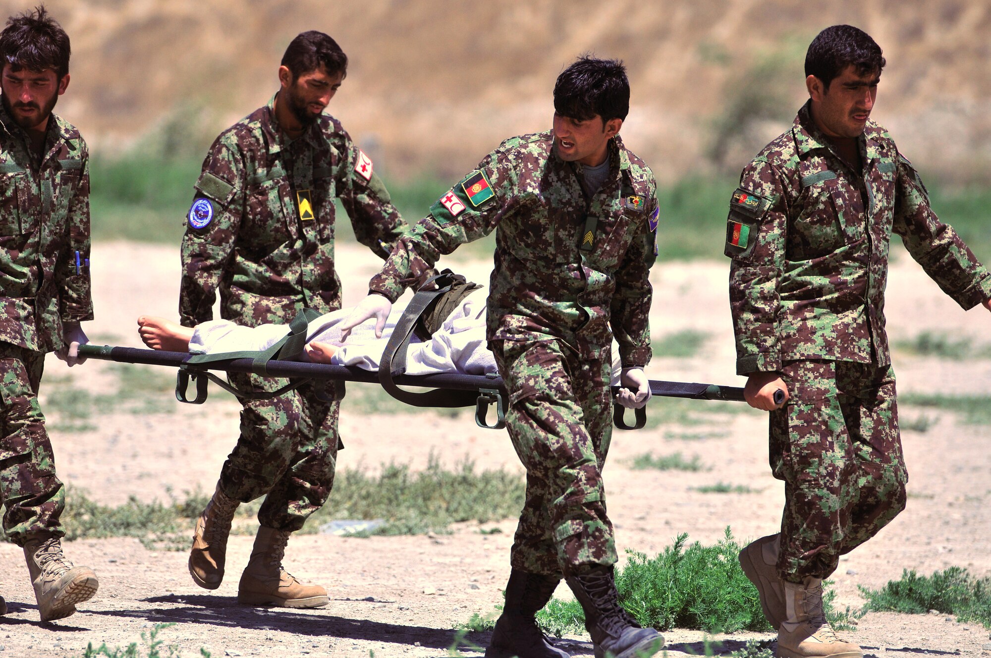 KABUL, Afghanistan -- Medics from the Afghan Air Force respond to a mass casualty training exercise at the Kabul International Airport June 19.  438th Air Expeditionary Wing Airmen initiated the exercise in an effort to evaluate the AAF medics' response, triage and transportation capabilities.  The advisors work shoulder-to-shoulder to train the AAF in an advisory role.  (U.S. Air Force photo by Tech. Sgt. Brian E. Christiansen)