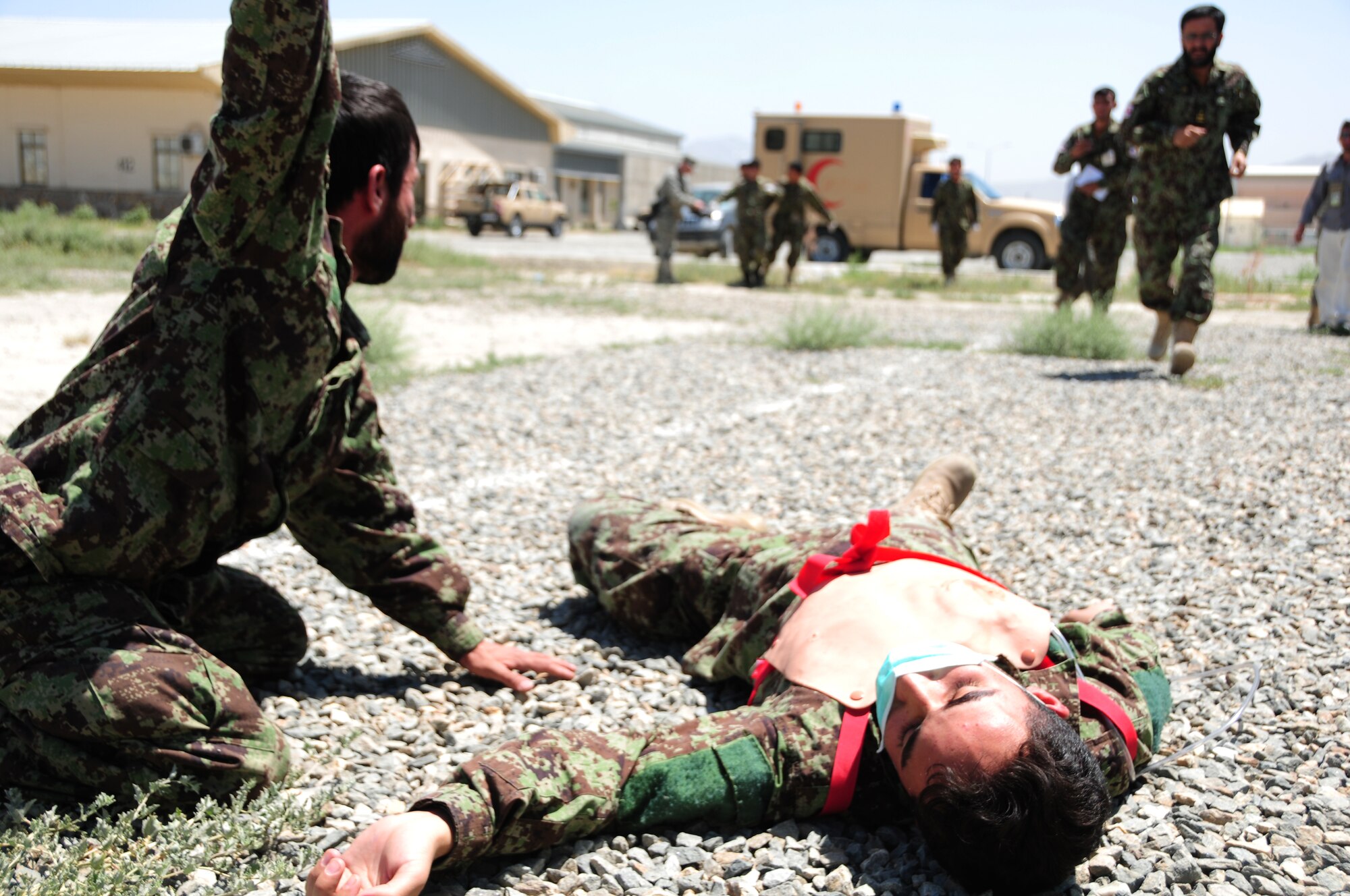 KABUL, Afghanistan -- Medics from the Afghan Air Force respond to a mass casualty training exercise at the Kabul International Airport June 19.  438th Air Expeditionary Wing Airmen initiated the exercise in an effort to evaluate the AAF medics' response, triage and transportation capabilities.  The advisors work shoulder-to-shoulder to train the AAF in an advisory role.  (U.S. Air Force photo by Senior Airman Amber Williams)