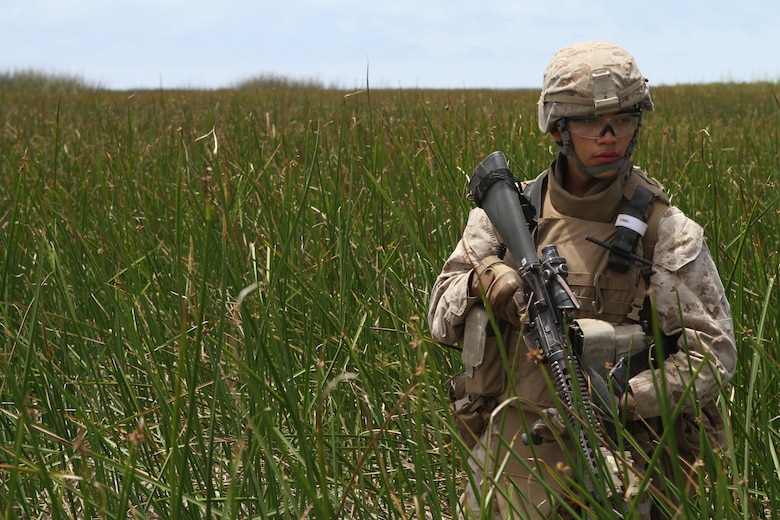 Pfc. Antonio L. Renteria uses stealth techniques while moving through a field here June 19. Renteria, a 20-year-old Oak Lawn, Ill., native, serves with Battalion Landing Team 3/1, the ground-combat element for the 11th Marine Expeditionary Unit.