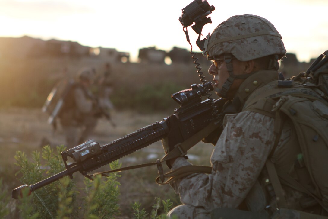 Pfc. Enrique Correa provides security while rehearsing for a night raid here June 19. Correa, an 18-year-old Yuma, Ariz., native, serves as a Rifleman with Company L, one of three rifle companies in Battalion Landing Team 3/1, the ground-combat element for the 11th Marine Expeditionary Unit. The unit recently began its first full-scale exercise since becoming a complete Marine air-ground task force in May.