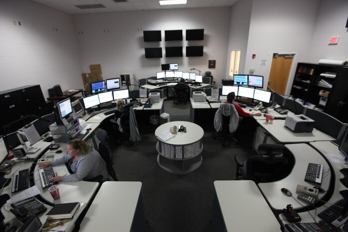 Amanda Scott (front left), Angela Wade (back left) and Sheryl Ripley (back right) man the core of the Marine Corps Base Camp Lejeune 911 Emergency Consolidated Communications Center.  The center is responsible for 911 calls from Marine Corps Base Camp Lejeune, Marine Corps Air Station New River and the satellite facilities.