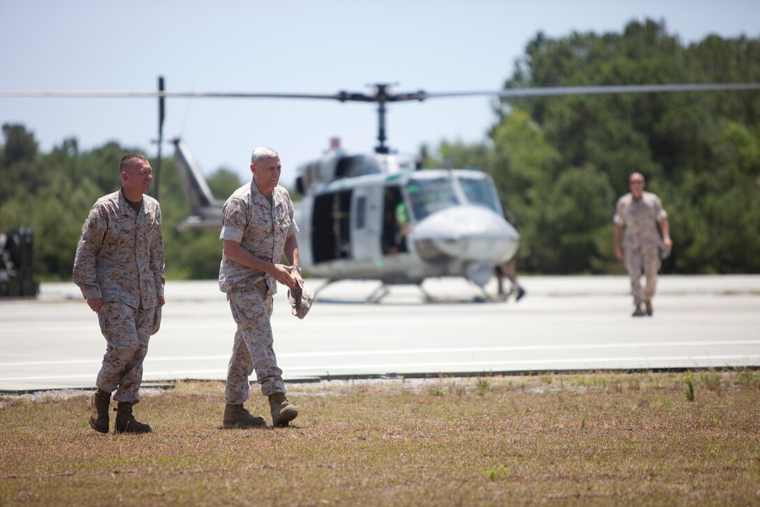 Maj. Gen. Jon M. Davis, left, 2nd Marine Aircraft Wing commanding general, and Lt. Gen. John M. Paxton, right, II Marine Expeditionary Force commanding general, arrive at Marine Corps Auxiliary Landing Field Bogue, N.C., after riding in a UH-1N Huey with Marine Light Attack Helicopter Squadron 167 June 20 to observe operations taking place in support of Operation Mailed Fist.