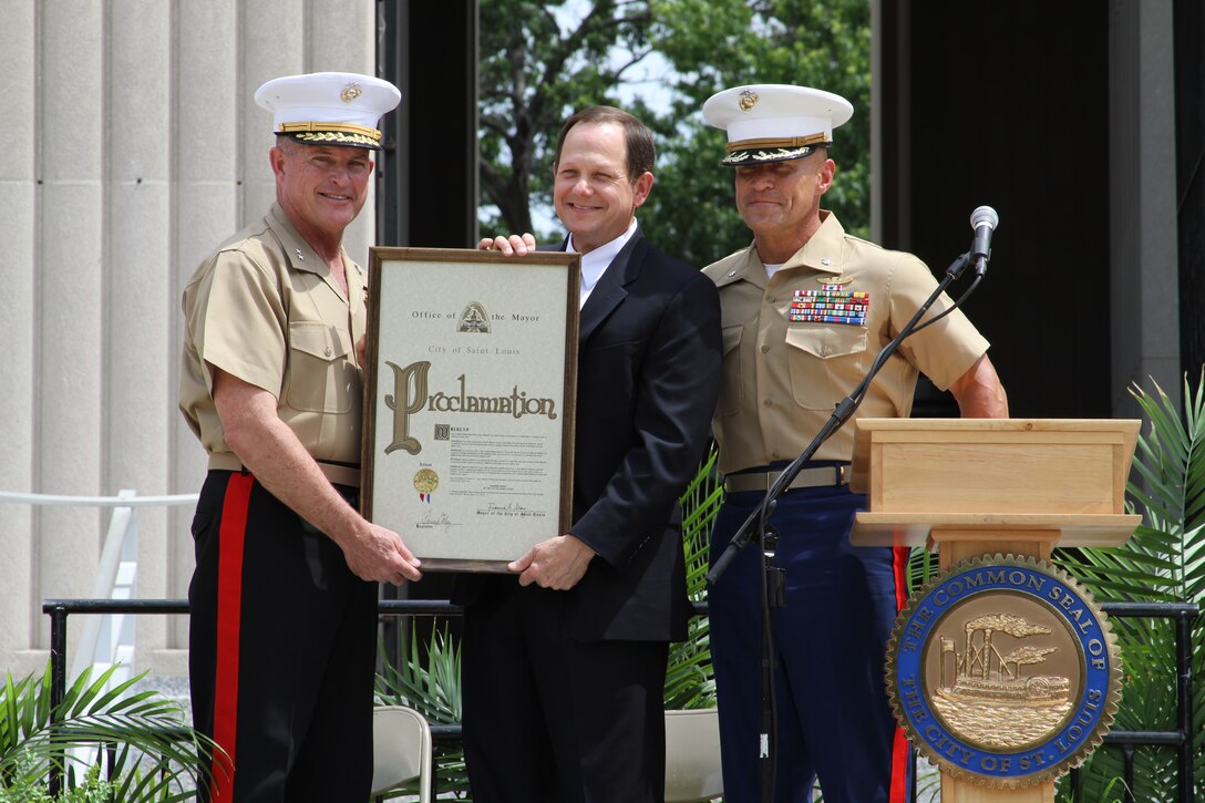 The mayor of St. Louis, Francis G. Slay, hands a proclamation to Major Gen. Raymond C. Fox, commanding general, Training and Education Command, and Lt. Col. T. Shane Tomko, commanding officer, 3/24, Special Purpose Marine Air Ground Task Force Marine Week. The proclamation declared the week of 20 June to 26 June to be Marine Week in St. Louis. The Marines will hold different events and performances over the course of the week, and will also be involved in various volunteer efforts throughout the city.