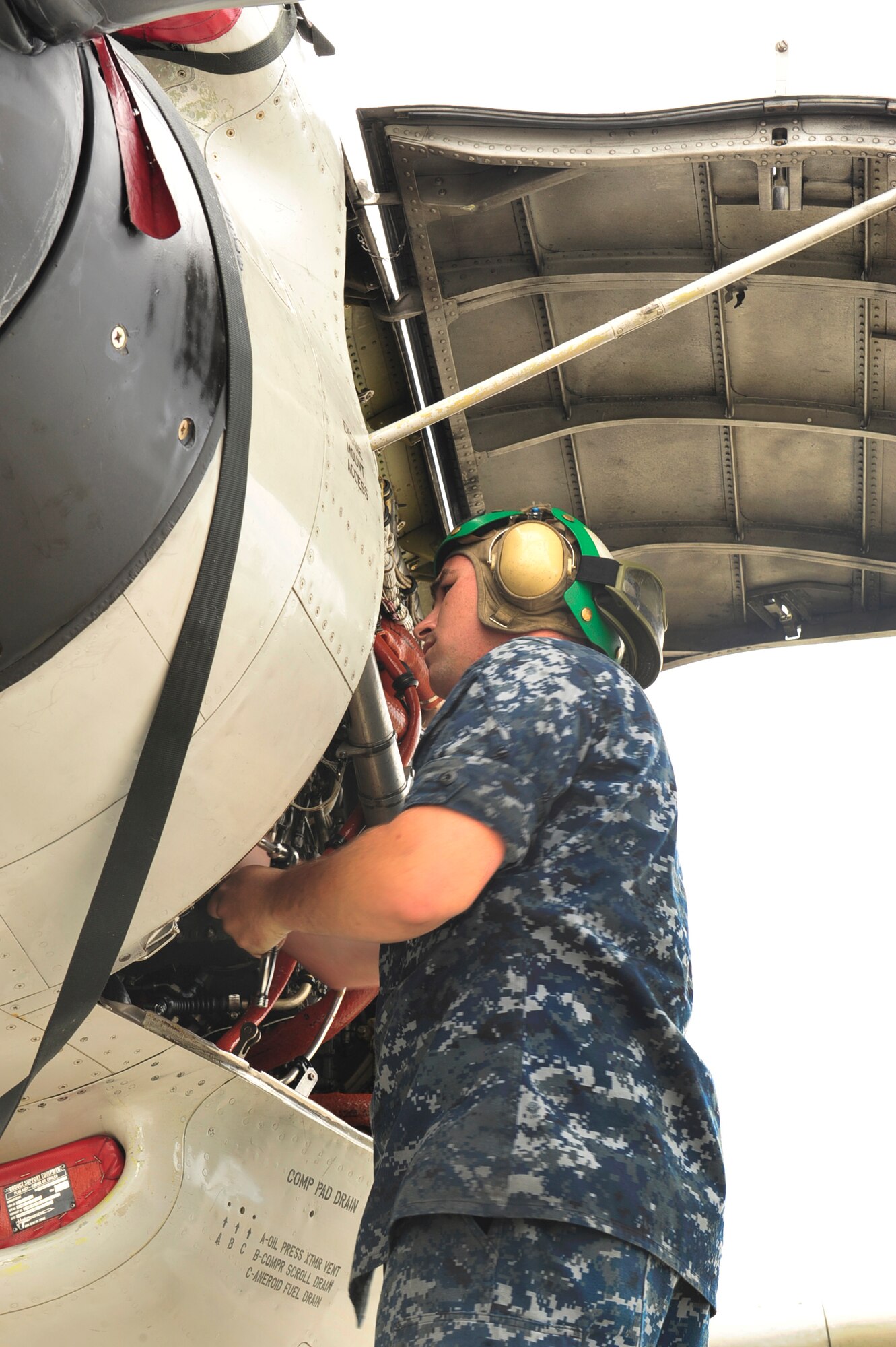 United States Navy Petty Officer 3rd Class Shane Marlow, an aviation mechanic with the U.S. Navy Patrol Squadron One, Whidbey Island, Washington, performs post flight maintenance on a LSRS (P3) during the Northern Edge Premier Joint Training Exercise at Eielson Air Force Base, Alaska, June 20. Participants in the exercise practice techniques and tactics correlating with defensive counter air, close air support, air exclusion of marine targets, and personnel recovery operations. (U.S. Air Force photo/ Staff Sgt. Lakisha)