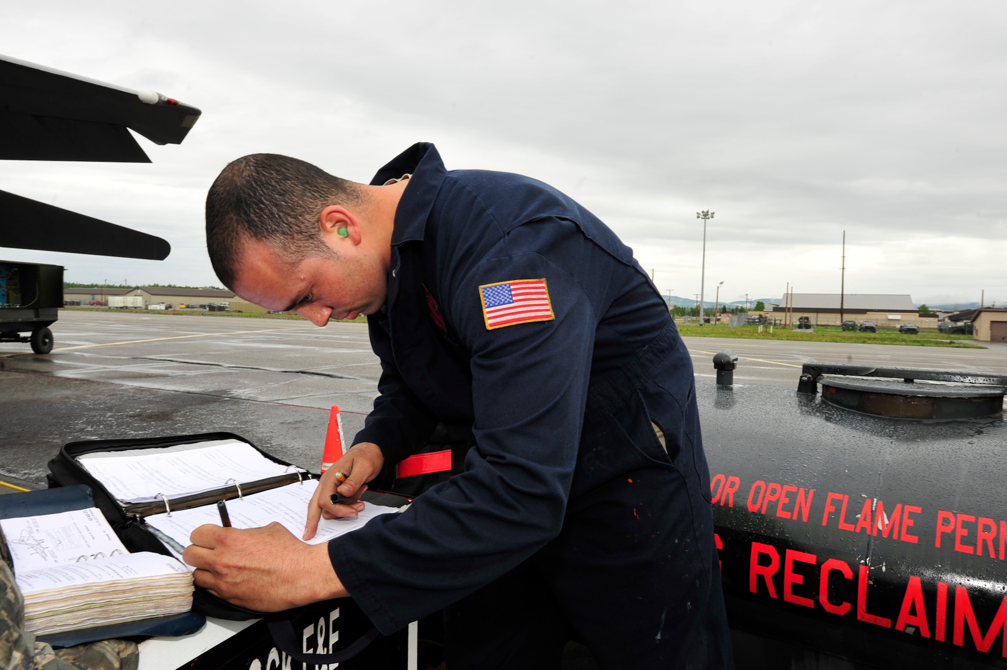 U.S. Air Force Senior Airman Joshua Brown, an electrical/environmental technician with the 18th Aircraft Maintenance Squadron, Kadena Air Base, Japan, checks and documents forms during a gear swings check at the Northern Edge Premier Joint Training Exercise at Eielson Air Force Base, Alaska, June 20. Northern Edge 2011, allows military members to hone existing skills and test future productions of weapon potentials. (U.S. Air Force photo/ Staff Sgt. Lakisha A. Croley)